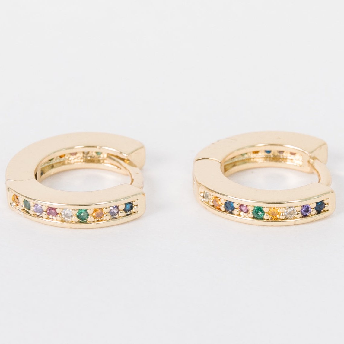 14k Gold Filled 12 mm huggie clasp Safe for sensitive skin Unique clasp has no post when earrings are closed, allowing for comfortable wear and sleep without having to remove earrings Multicolored bejeweld stones are 2 mm Perfect for mulitple piercings Freaking cute and freaking tiny
