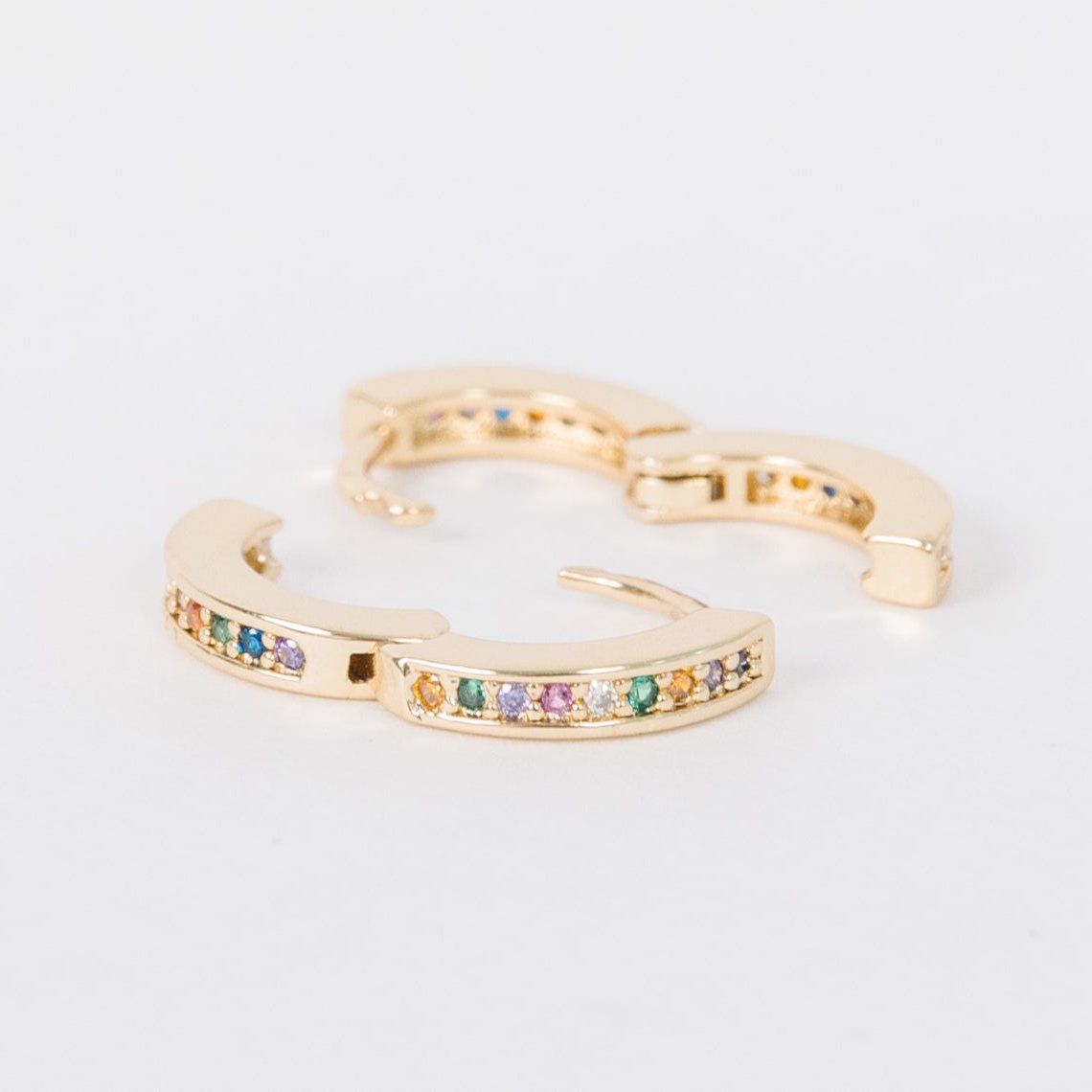 14k Gold Filled 12 mm huggie clasp Safe for sensitive skin Unique clasp has no post when earrings are closed, allowing for comfortable wear and sleep without having to remove earrings Multicolored bejeweld stones are 2 mm Perfect for mulitple piercings Freaking cute and freaking tiny