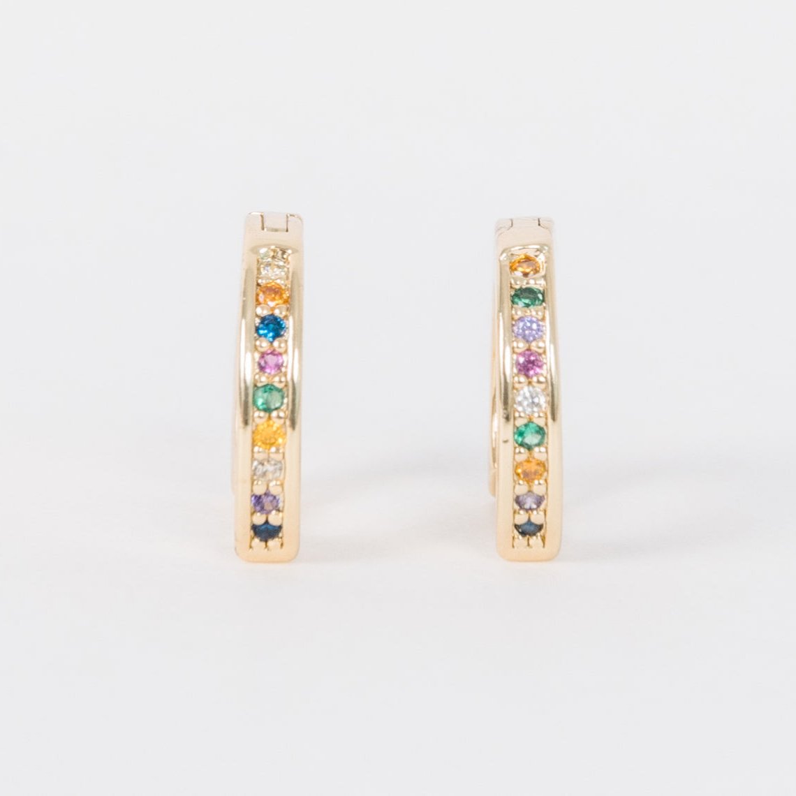 14k Gold Filled 12 mm huggie clasp Safe for sensitive skin Unique clasp has no post when earrings are closed, allowing for comfortable wear and sleep without having to remove earrings Multicolored bejeweld stones are 2 mm Perfect for mulitple piercings Freaking cute and freaking tiny