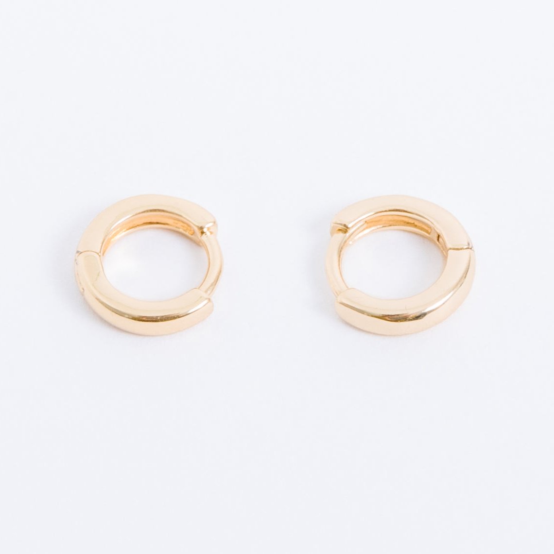 14k gold filled. Safe for sensitive skin. Unique clasp has no post when earrings are closed, allowing for comfortable wear and sleep without having to remove earrings. Available in 9 mm and 16 mm, Hypoallergenic, While gold filled is a strong, sturdy metal for maximum lifespan we don't recommend subjecting the earrings to lots of chemicals, waters, perfumes, etc.