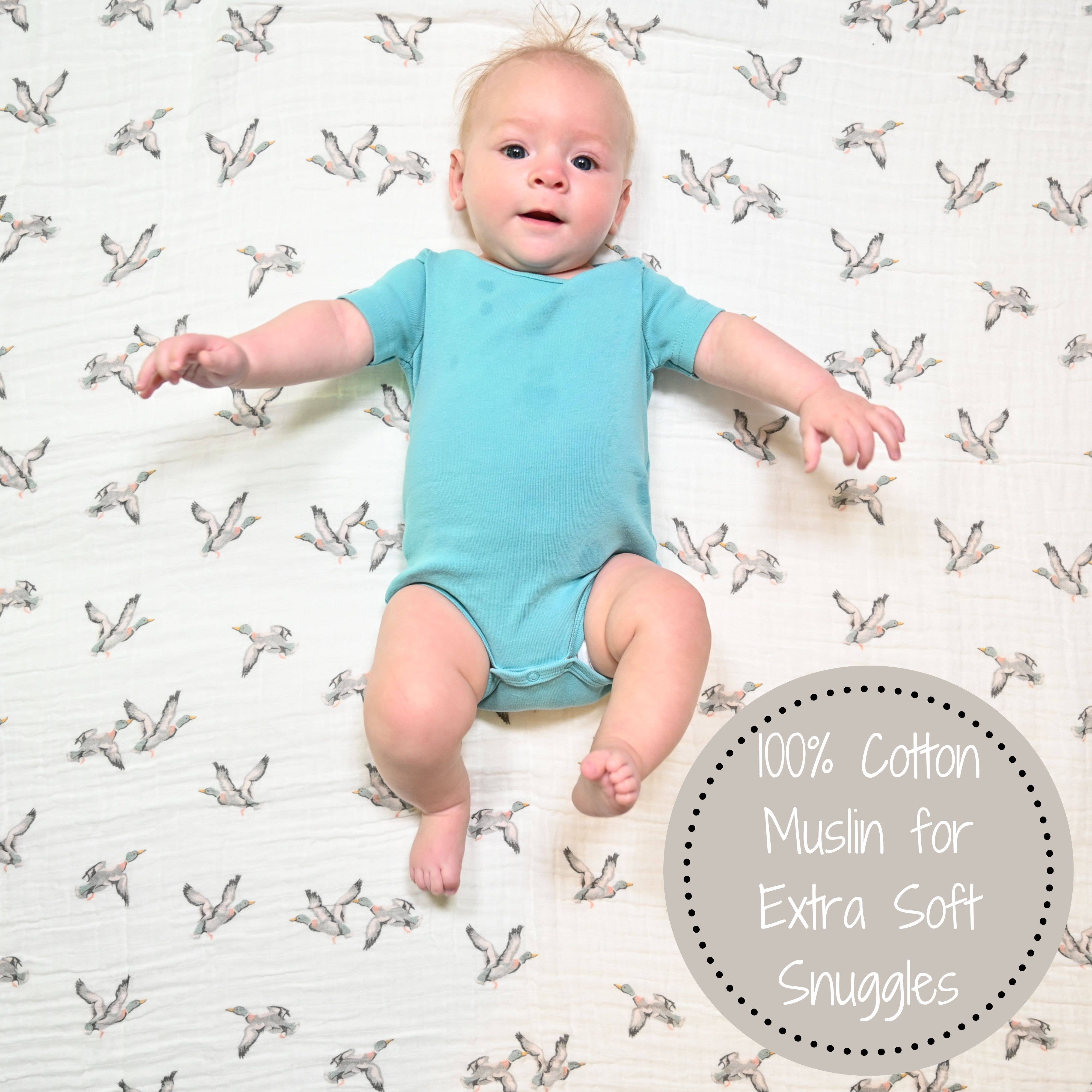 Baby in a light blue onesie on a white background with bird patterns, featuring text about cotton muslin.