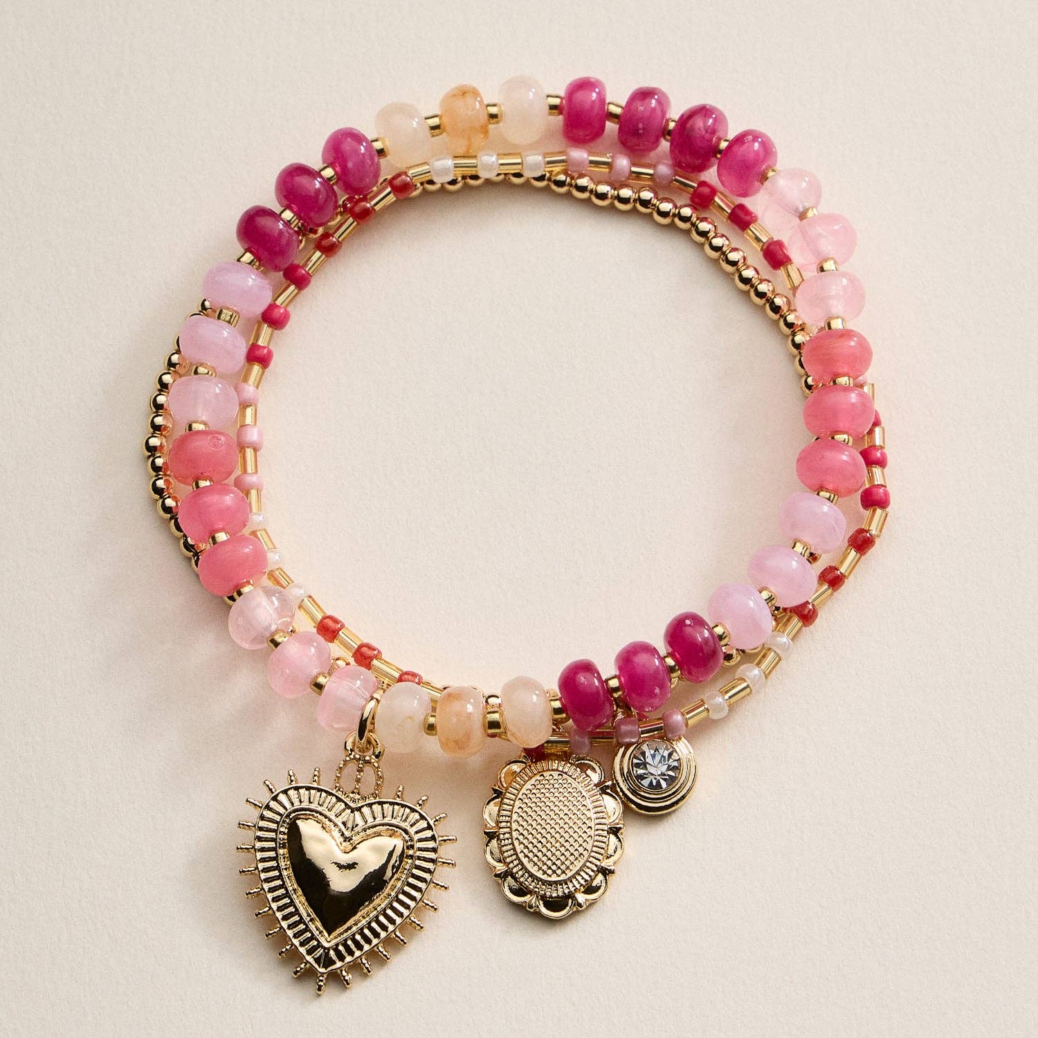 Bright and playful, this beaded bracelet set features three coordinating designs — a gold-tone beaded bracelet with charm pendants, a colorful stretch bracelet with a heart charm centerpiece, and a slim seed bead bracelet for a layered touch. Each piece adds a pop of color and shine, perfect for stacking or wearing solo for effortless charm and personality.
Details:
Material: Alloy, glass beads, acrylic beads, elastic cord
Design: Three-piece stretch bracelet set with mixed beaded textures and metallic