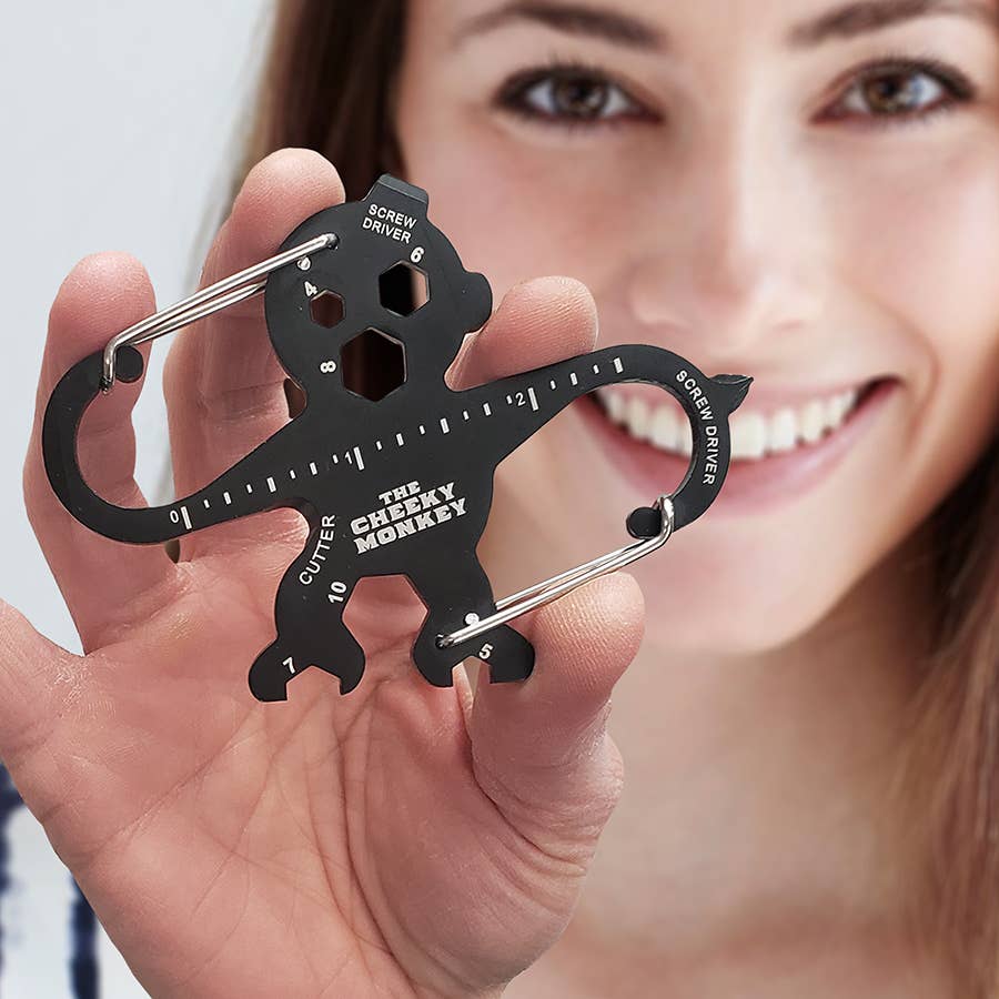 Person holding a multi-tool shaped like a monkey with 'The Cheeky Monkey' branding.