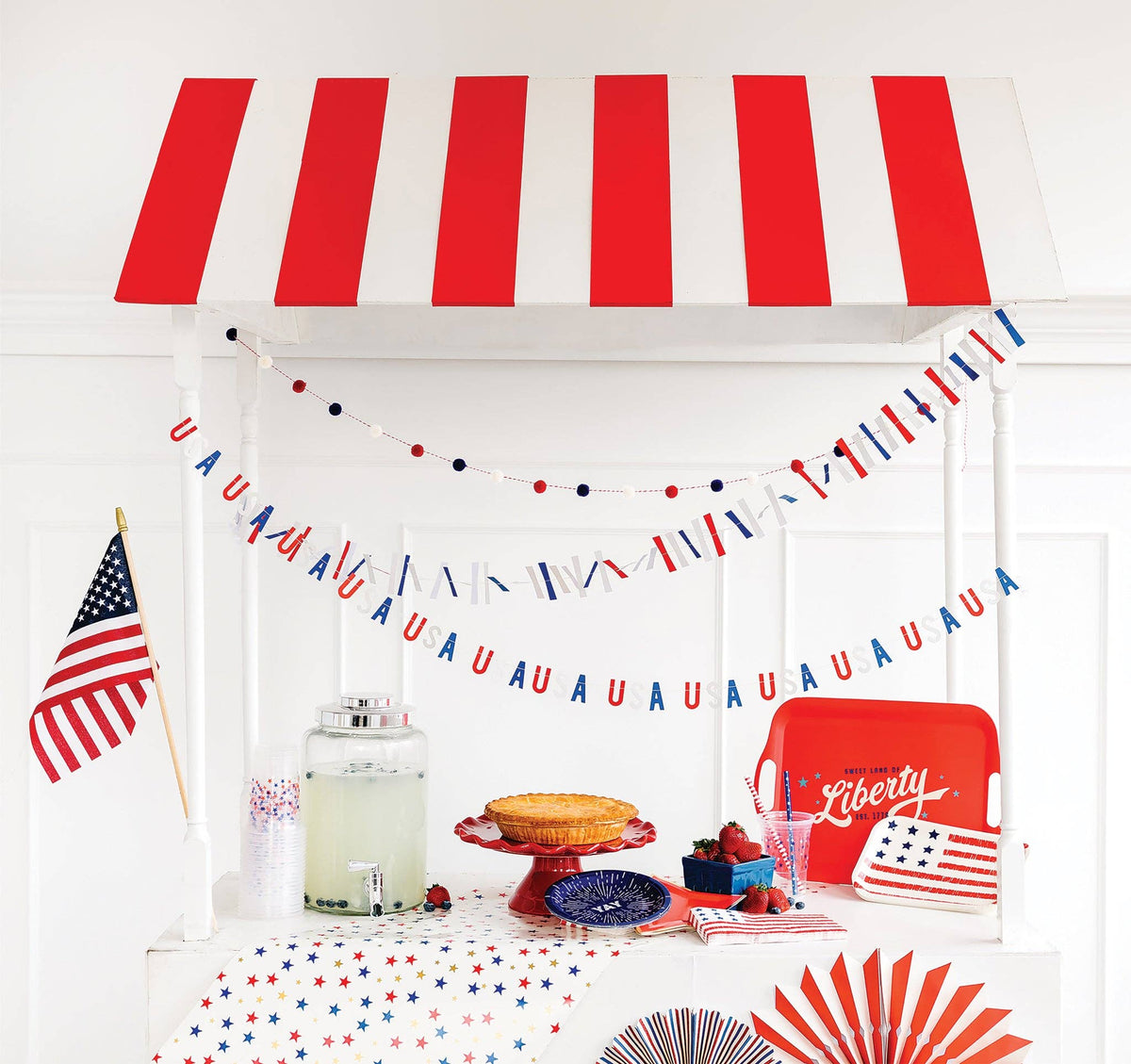 Celebrate the USA in red, white and blue with this festive banner set! This banner set includes red, white and blue pom pom banner, a mini USA banner, and a patriotic ticker tape banner. This banner set makes quick and stylish work of decorating a backyard barbeque or mantle display!
Details:
USA banner approximately 5 feet long pre-stitched
Pom pom banner approximately 5 feet long pre-strung
Ticker tape banner approximately 5 feet long pre-stitched
USA letters 1.5 inches tall
3 Sets Makes One Pack