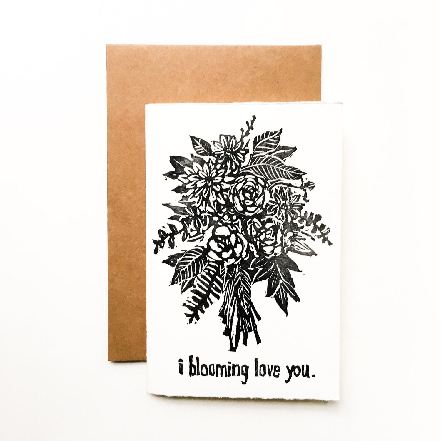 4x6 card hand carved and pressed reading "i blooming love you" with a black and white bouquet