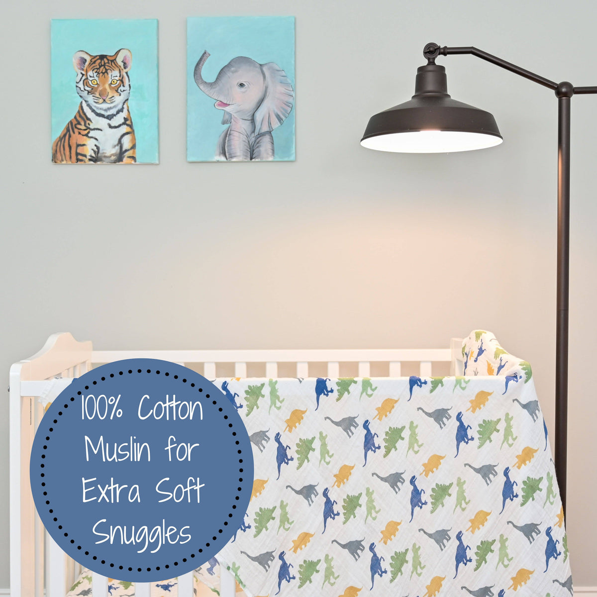 Nursery room with crib, lamp, and wall art of a tiger and an elephant.