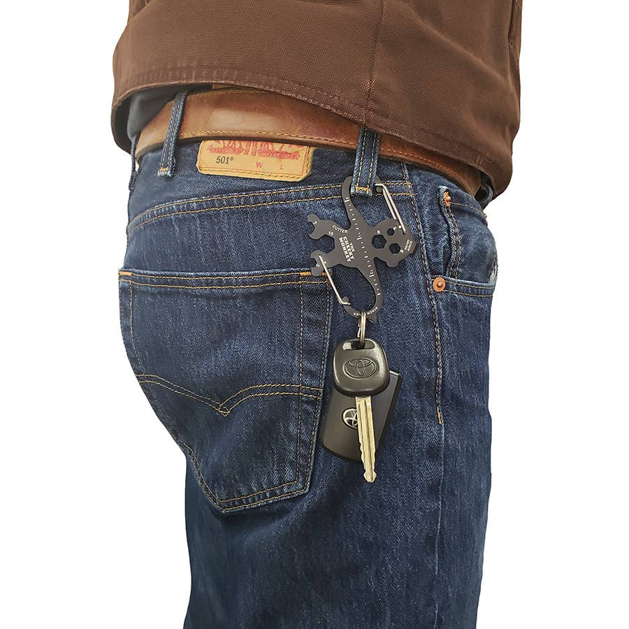 Person wearing blue jeans with a keychain attached to the pocket on a white background