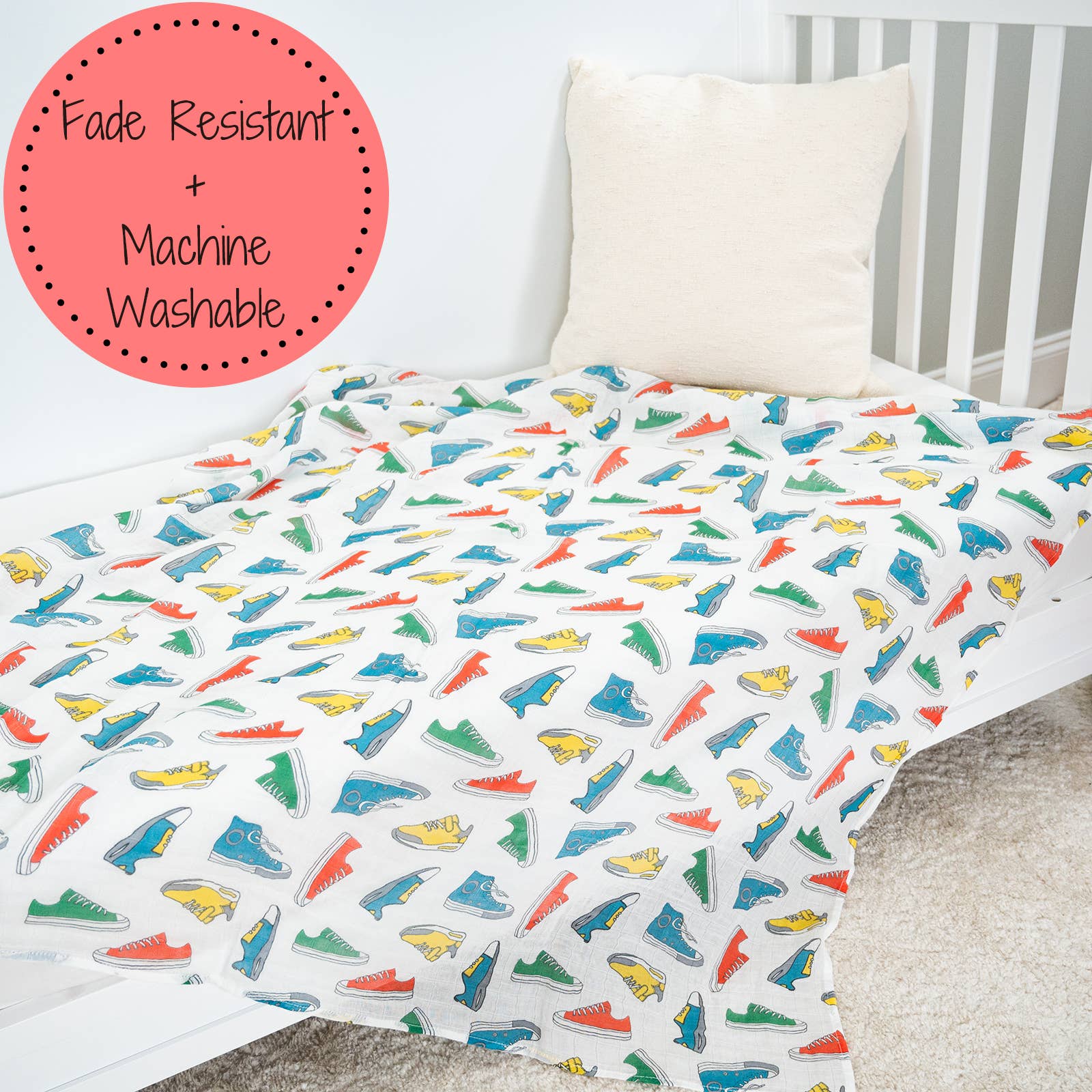 Colorful shoe patterned crib sheet on a crib with 'Fade Resistant + Machine Washable' label.