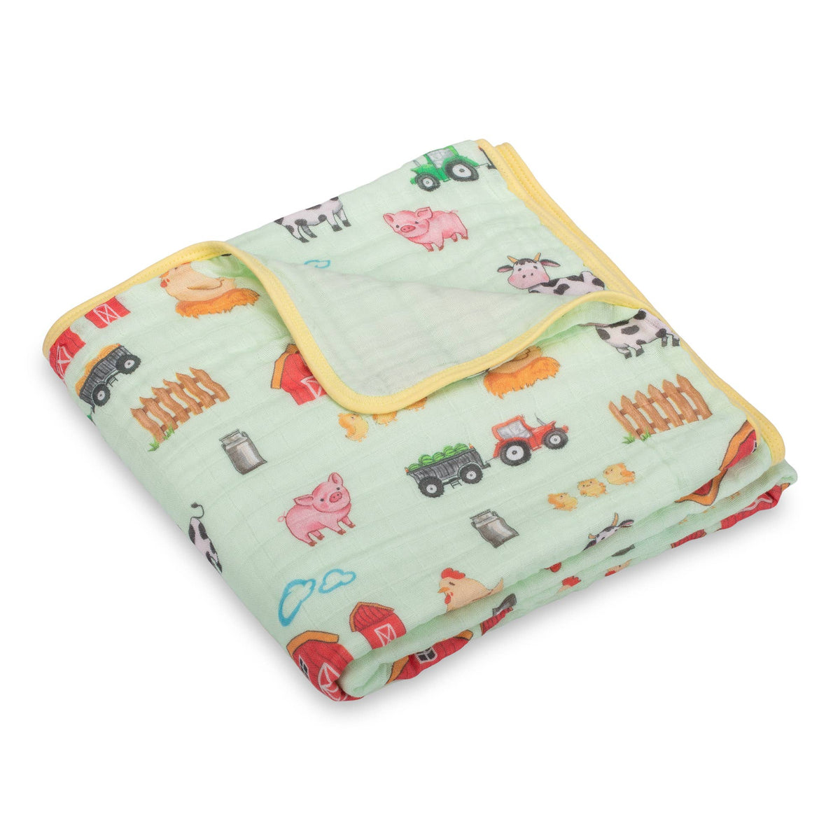 Children's blanket with farm animal and vehicle patterns on a light green background