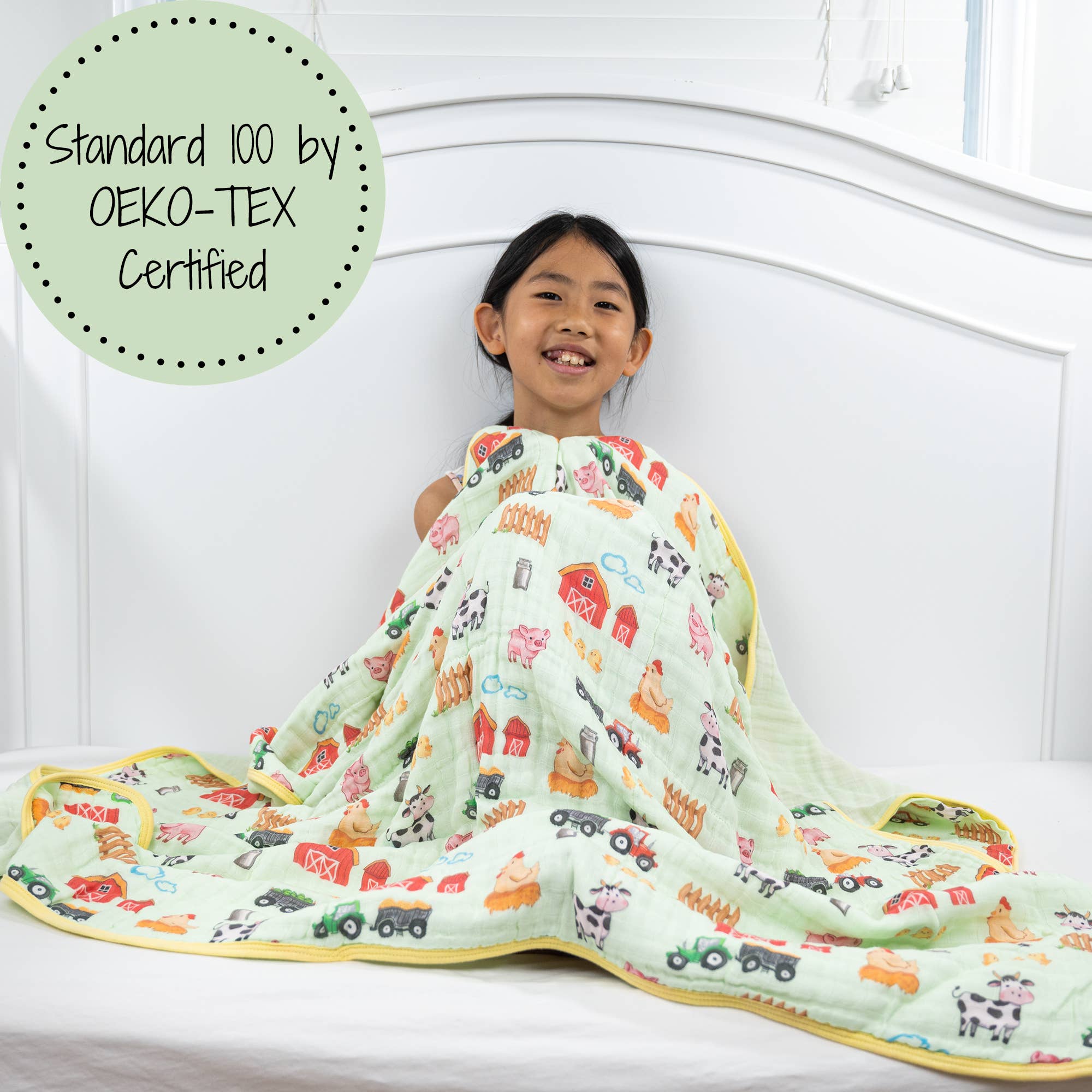 Child lying on a bed with a colorful quilt, featuring Oeko-Tex certification label.
