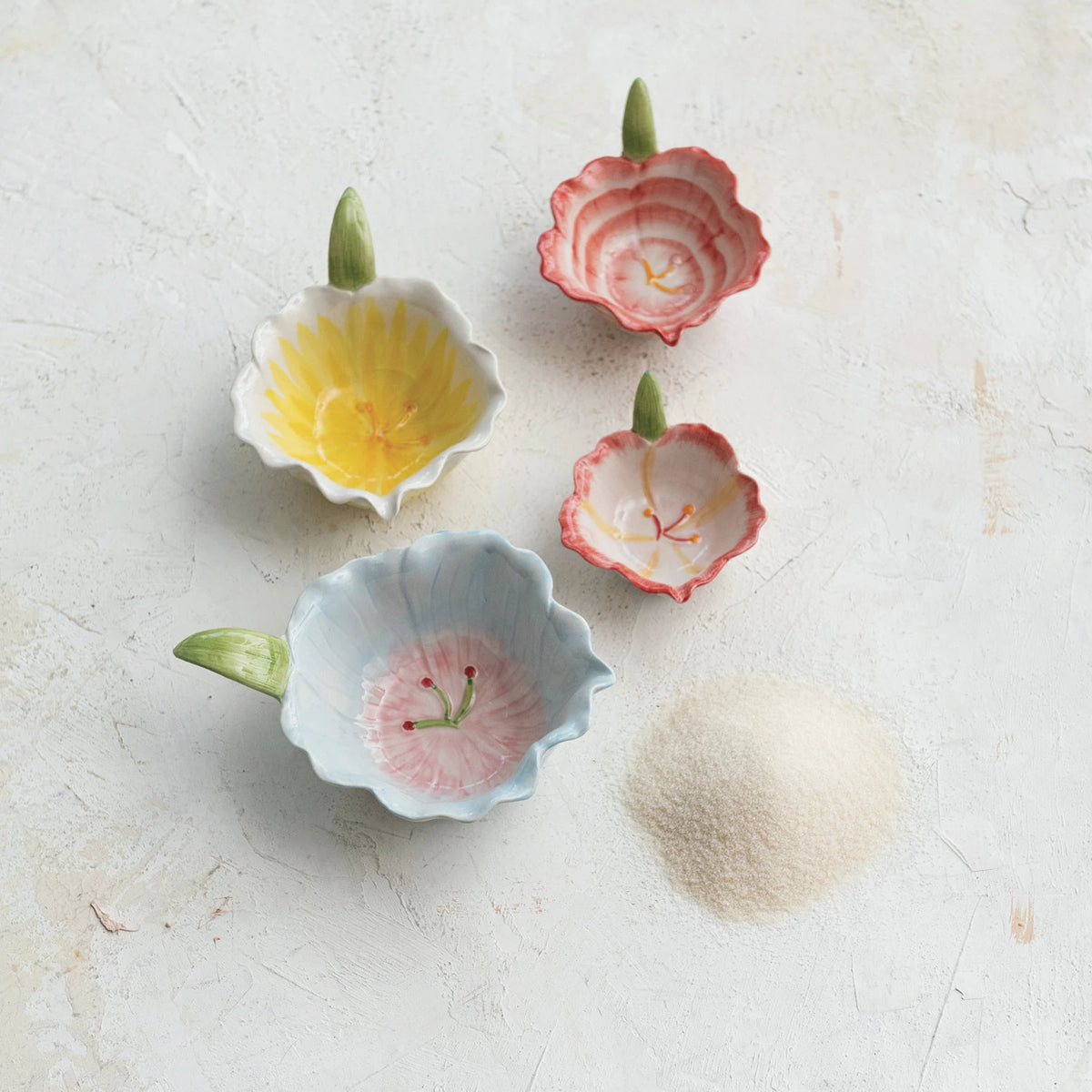 Add a touch of whimsy to your home with our hand-painted stoneware flower-shaped bowl! Perfect for small snacks or holding jewelry, this bowl is both charming and functional. Spruce up your decor with this unique piece. 4"L x 3-1/4"W x 1"H