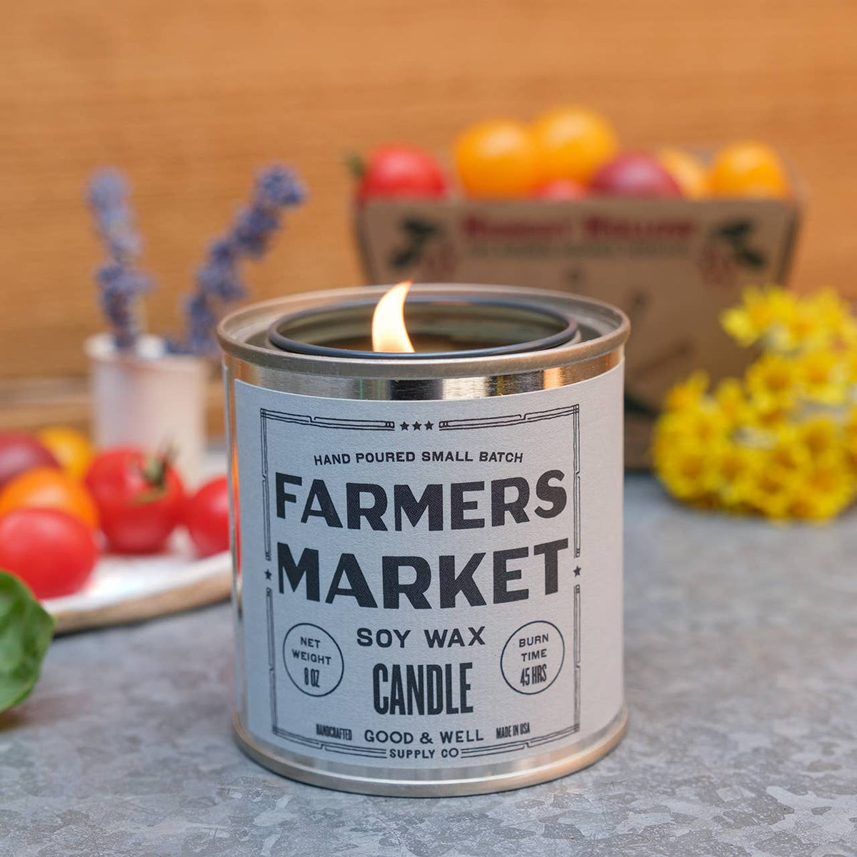 Farmers Market soy wax candle in a can with a wooden background and fruits.