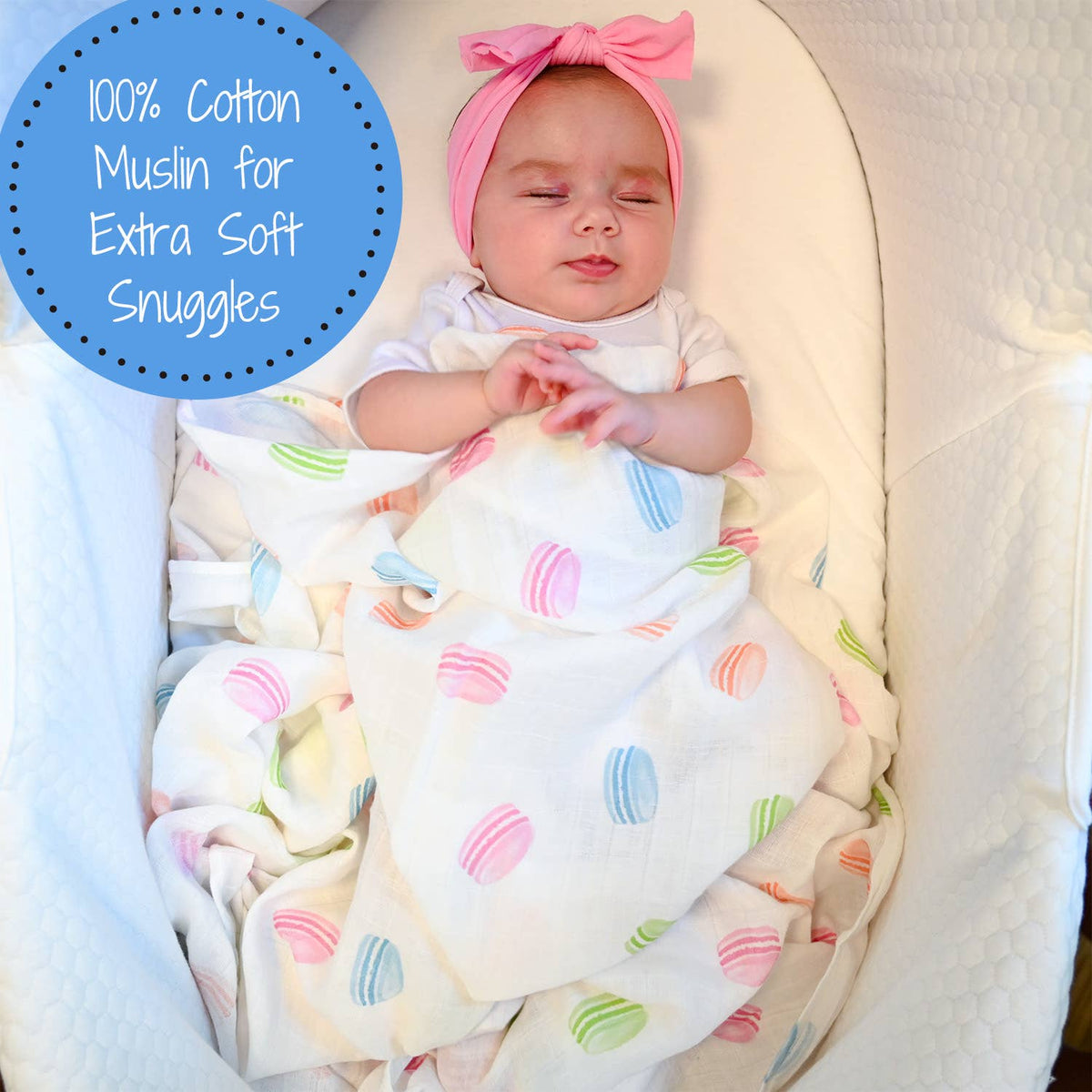 Baby wrapped in a colorful blanket with a pink bow, on a white background.