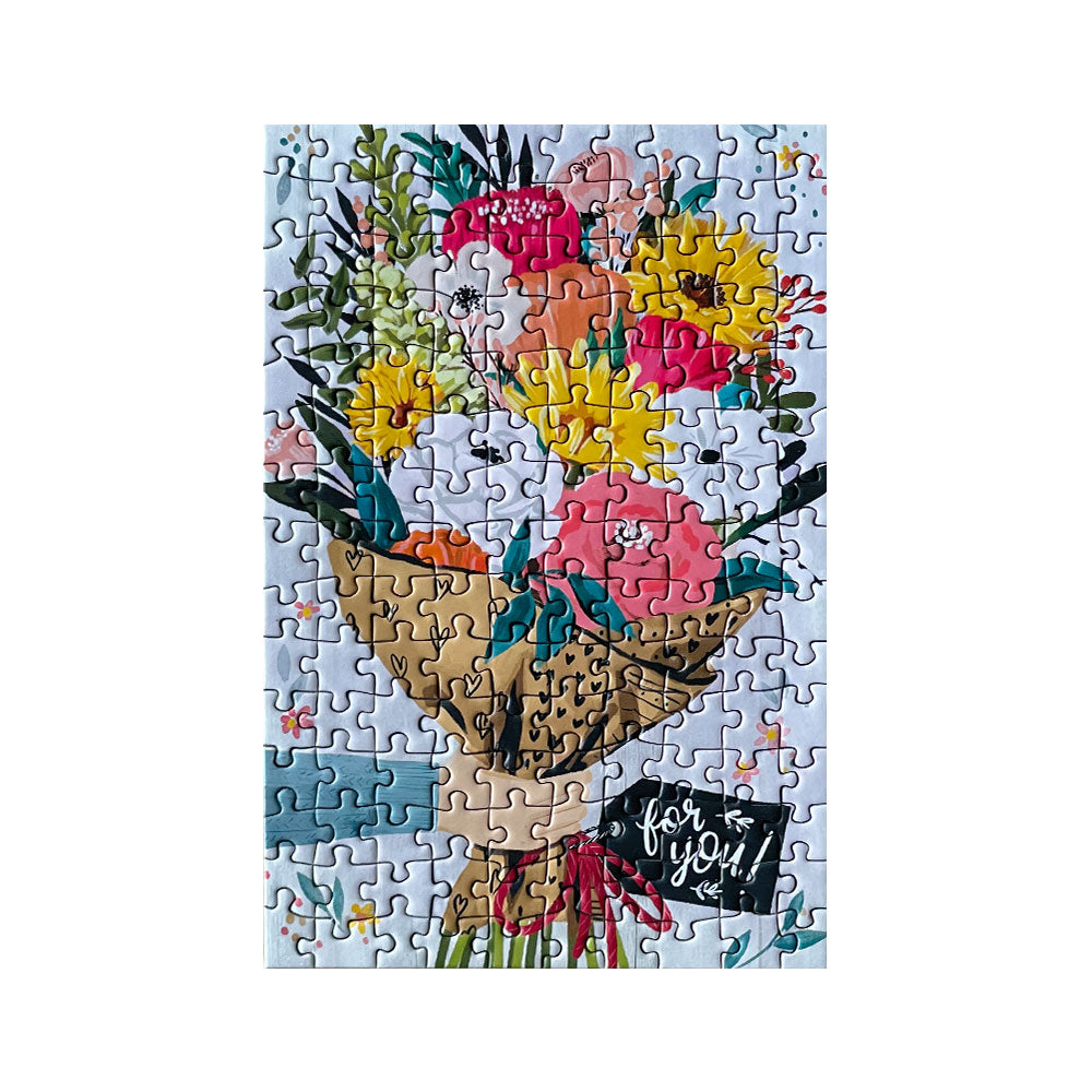 A completed 150 piece mini puzzle depicting a bouquet of colorful flowers.