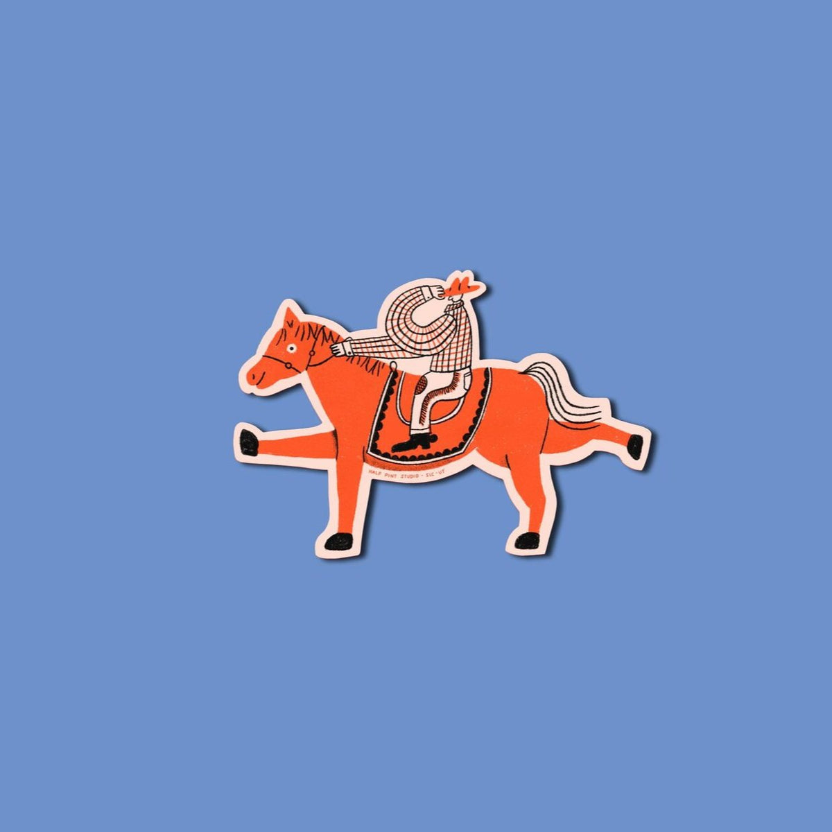 A fun cowboy on a red horse with a fun smile.