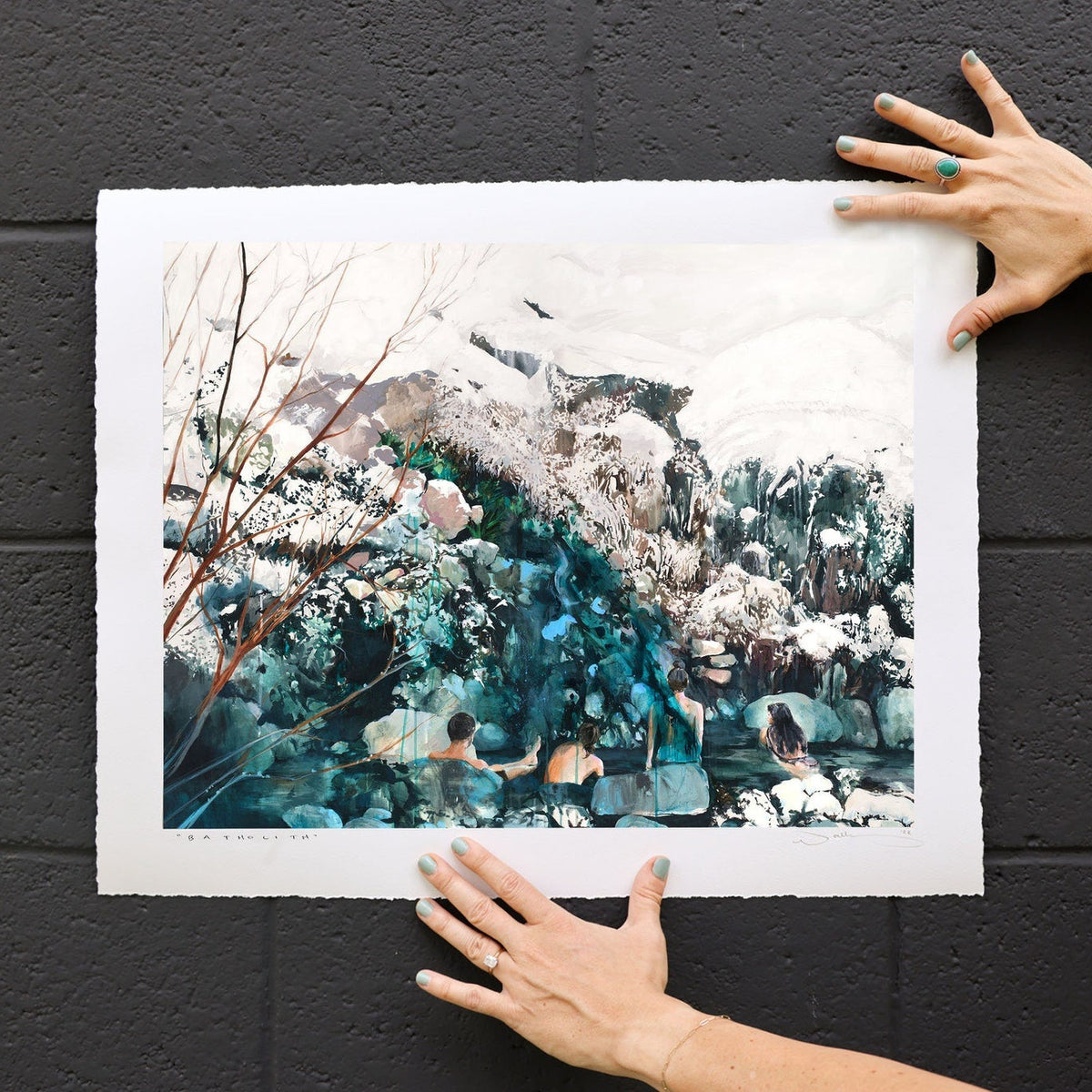 print held against black brick.