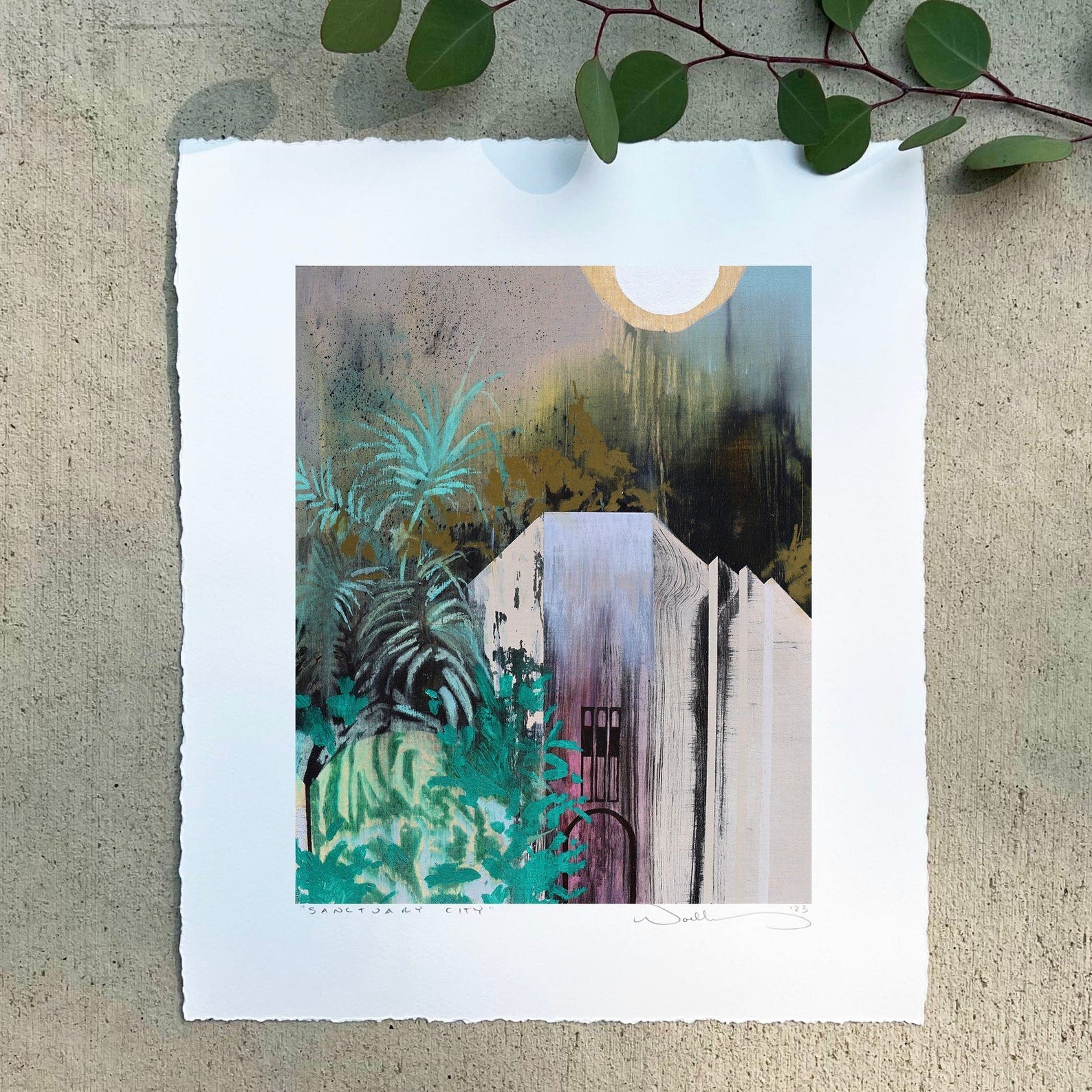 painting against cement with a eucalyptus branch.