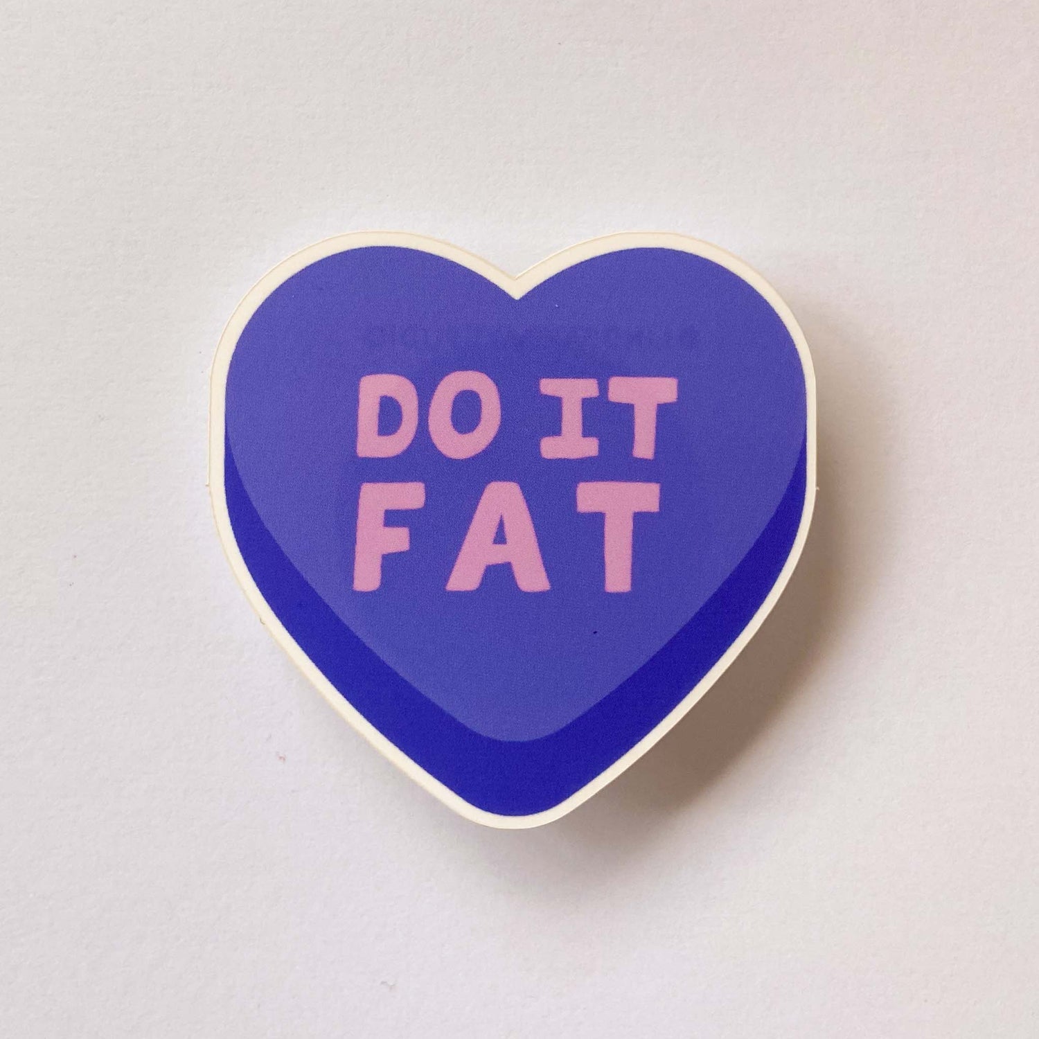Blue heart sticker that says "do it fat".