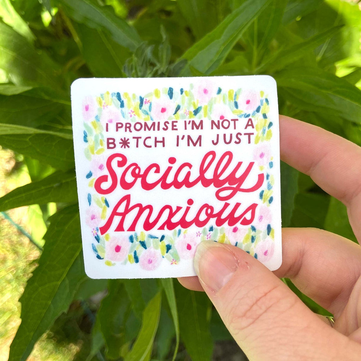 White square sticker with artsy floral design. Words say "I promise I'm not a bitch, I'm just socially anxious."