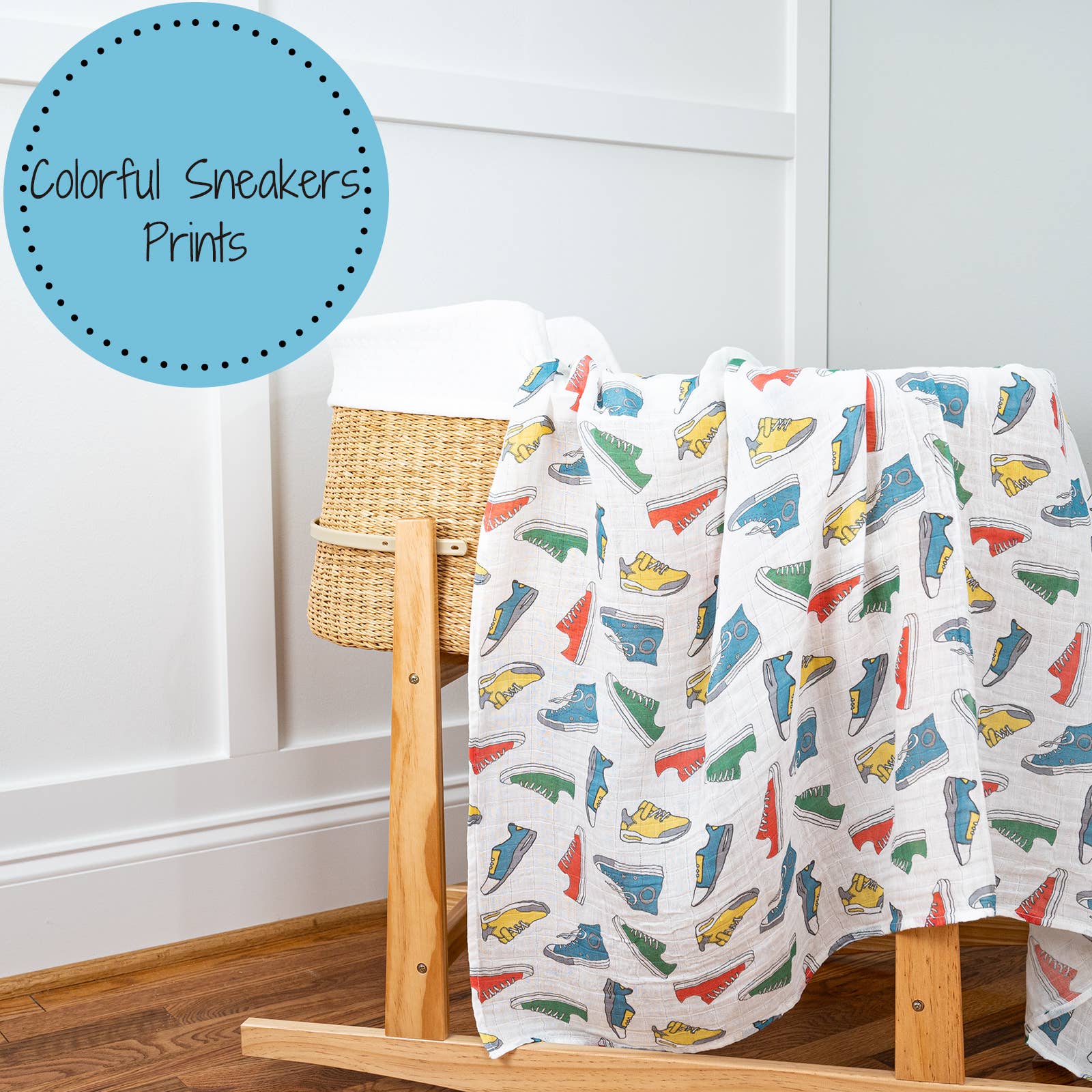 Blanket with colorful sneakers pattern draped over a wooden ladder against a white wall.