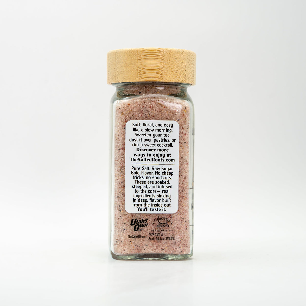 Back view of glass salt jar with wooden lid and labels. 