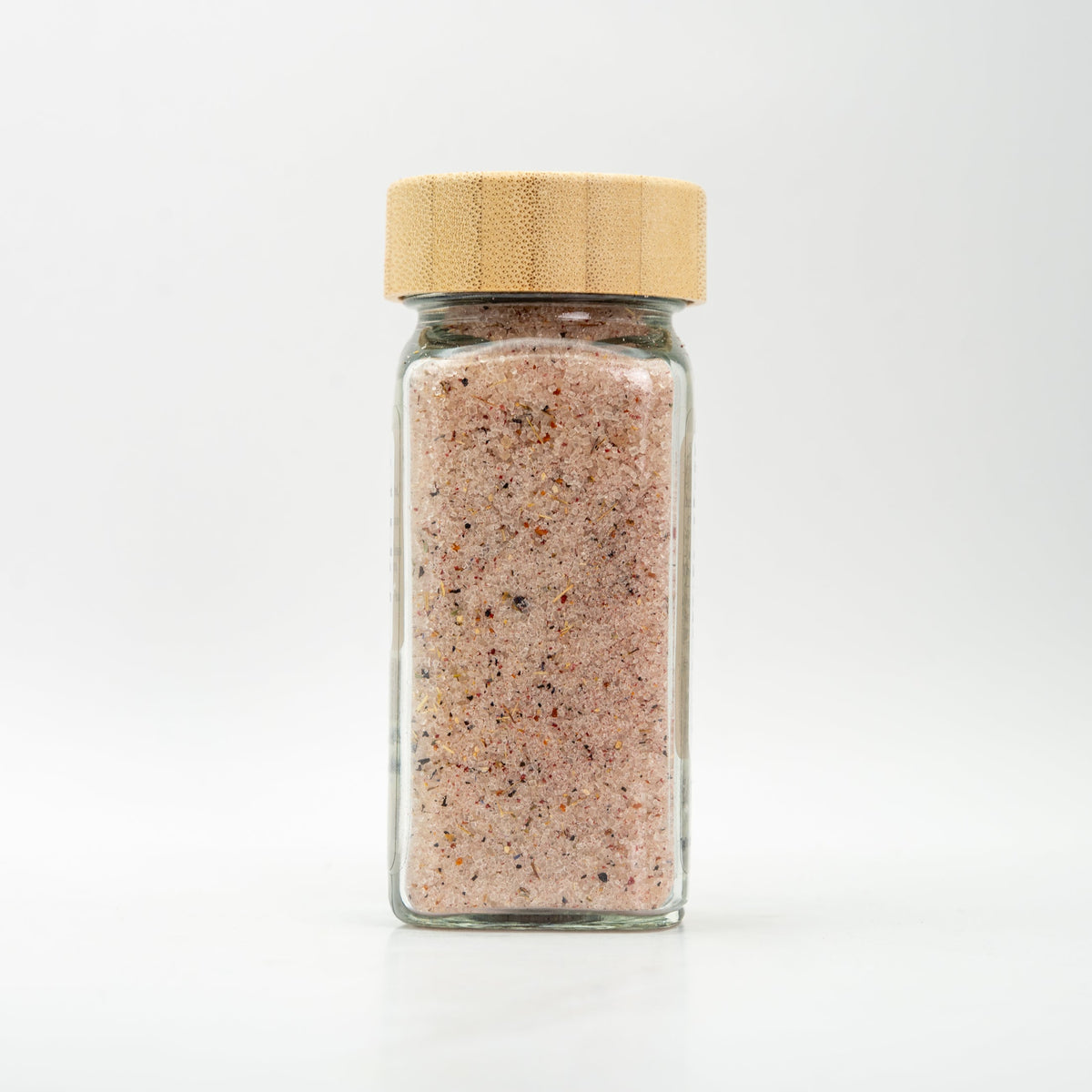 Unlabeled glass jar with wooden lid. 