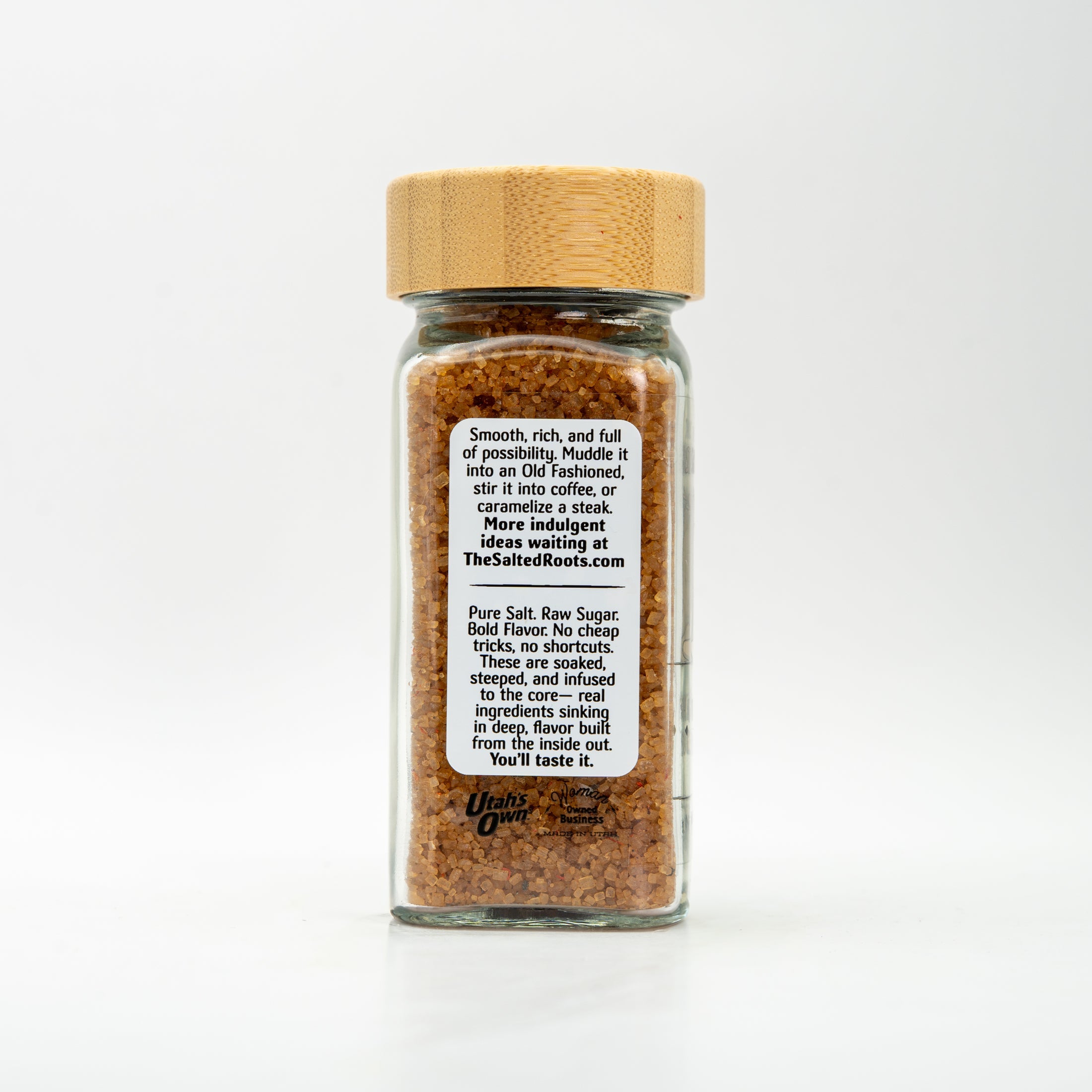 back view of glass salt jar with wooden lid and labels. 