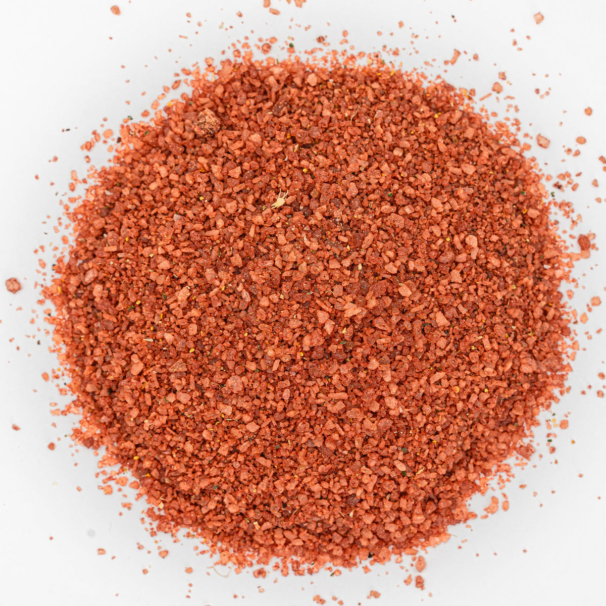 Red mound of salt with flecks of herbs. 