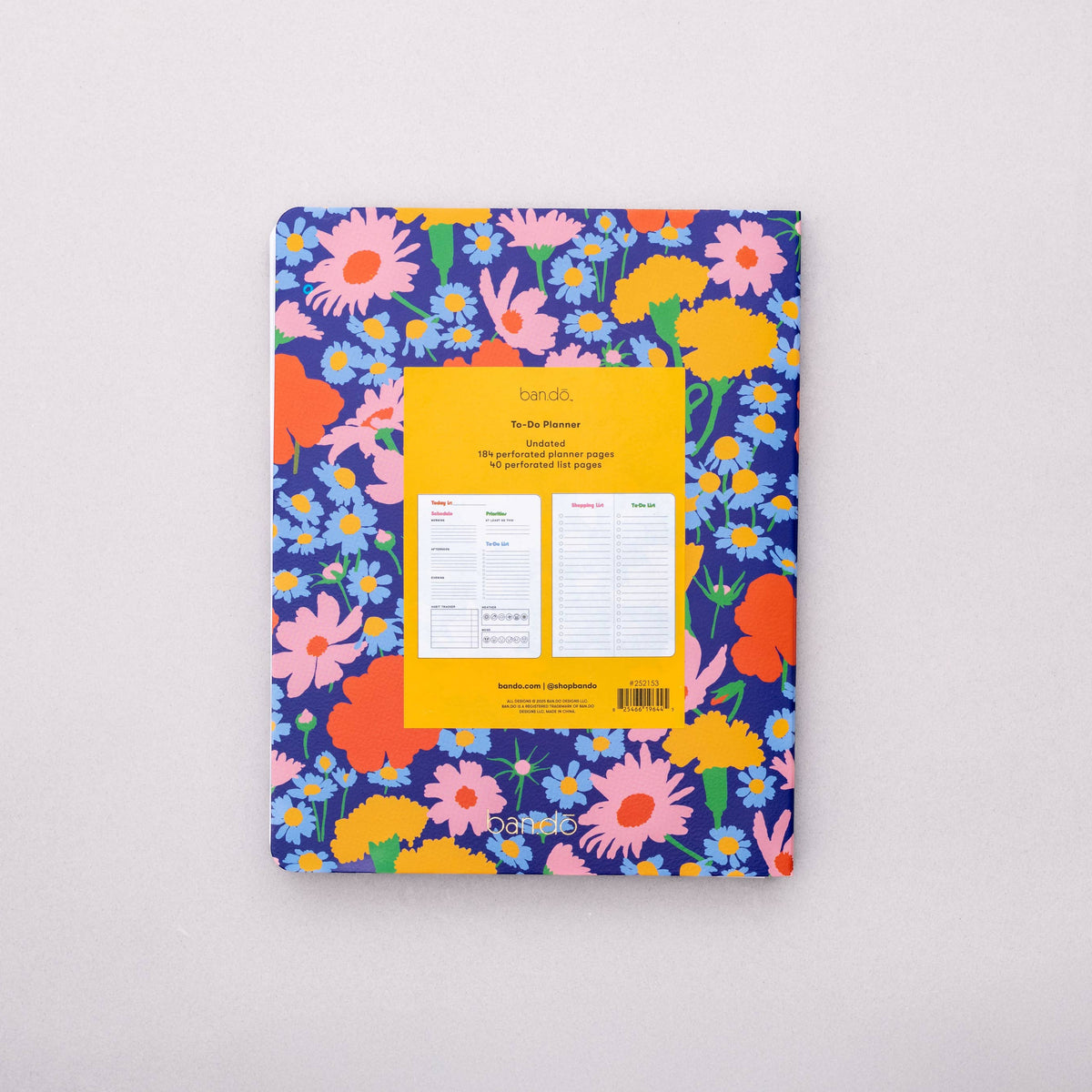Floral-patterned notebook with a yellow label on a light gray background