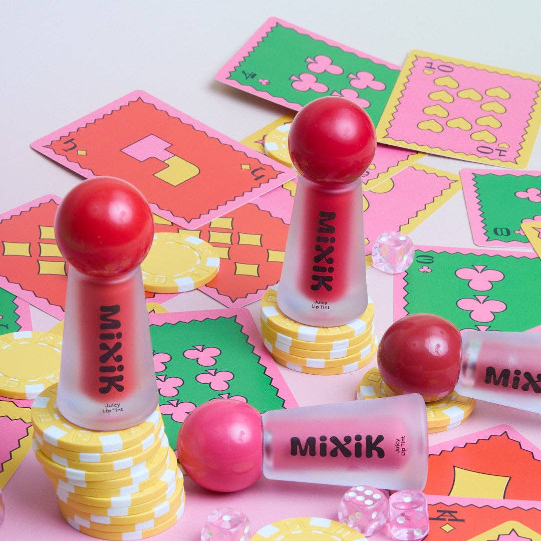Makeup products with 'MIXIK' branding on a colorful patterned surface