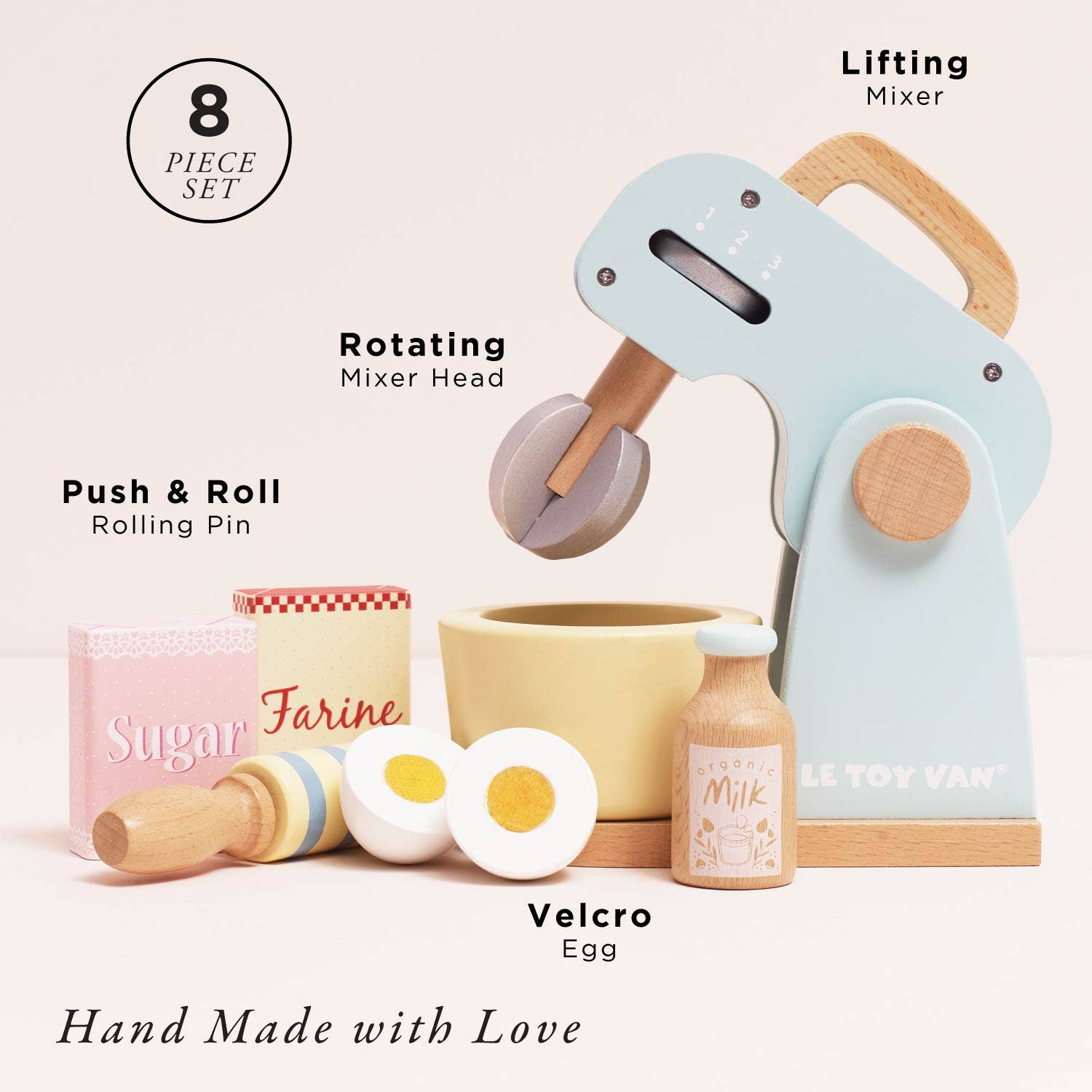 Set of toy kitchen items including a mixer, rolling pin, and eggs on a white background.