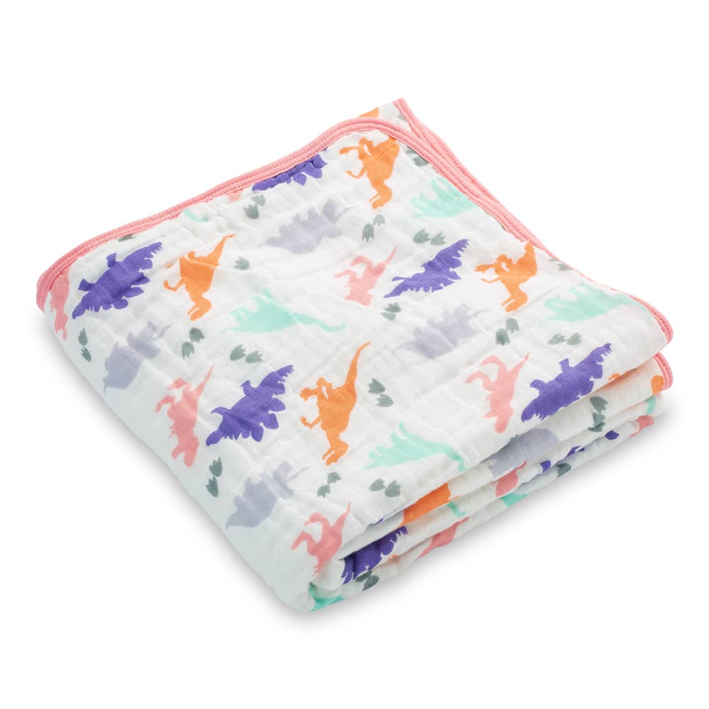 Folded baby blanket with colorful dinosaur pattern on a white background