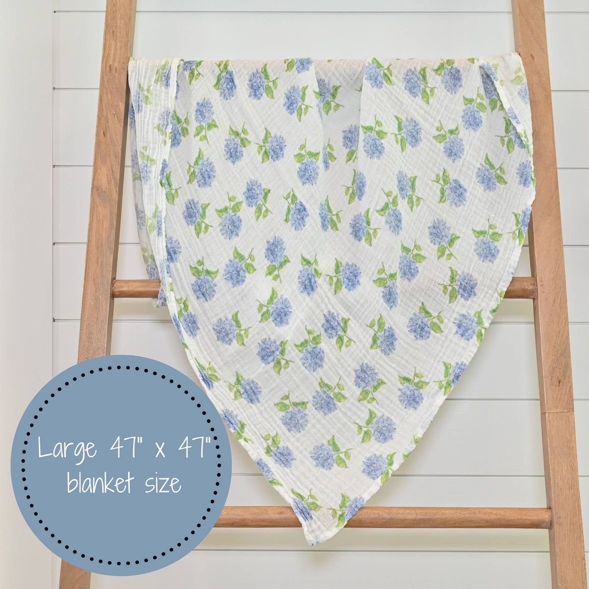 Floral patterned blanket draped over a wooden ladder on a white background
