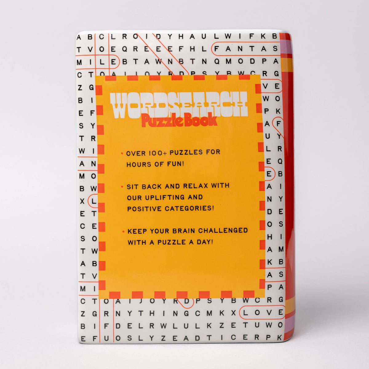 Puzzle book vase with a colorful cover on a white background