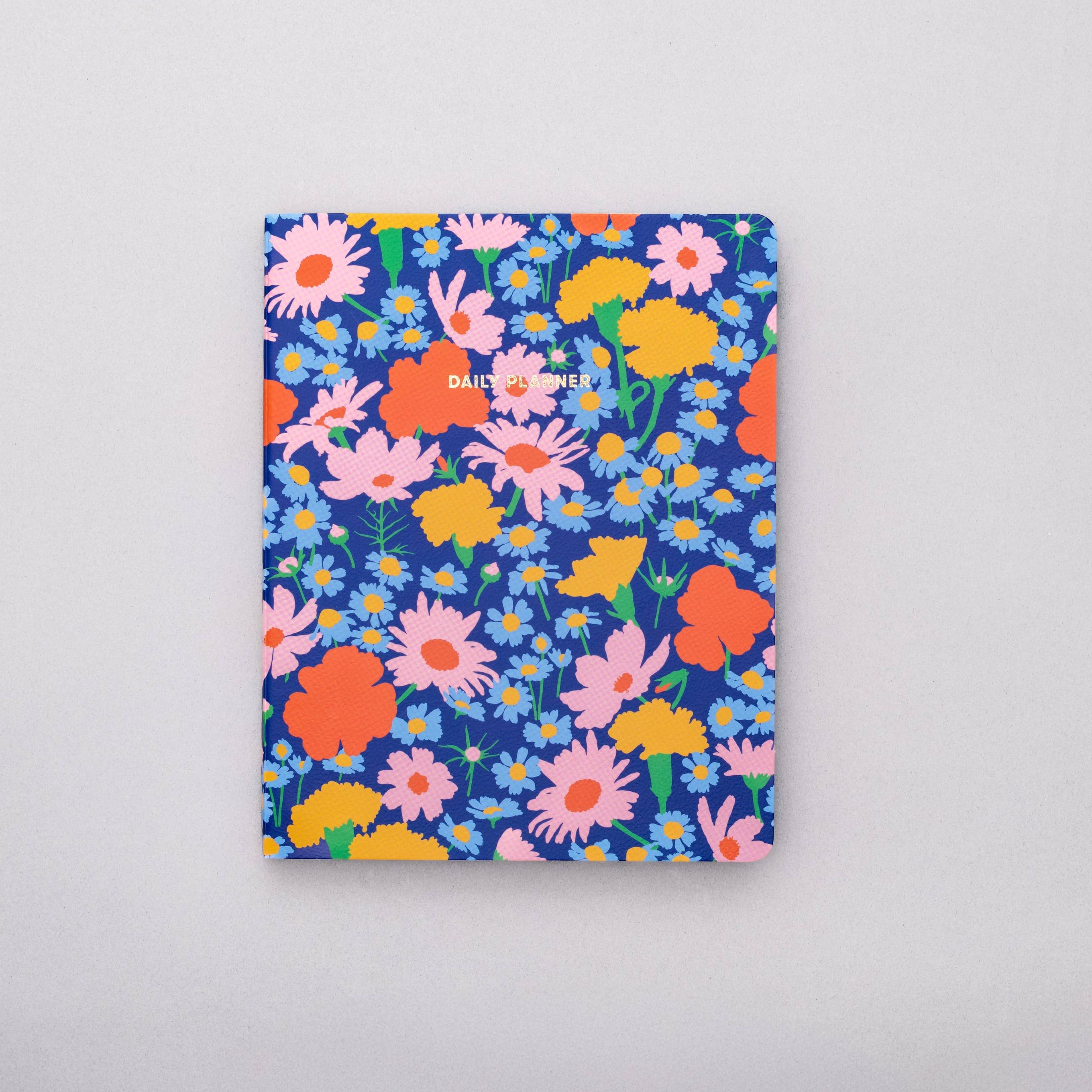 Floral-patterned notebook on a gray background
