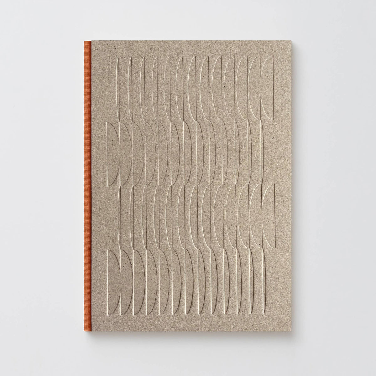 A minimalist notebook with a textured beige cover featuring an embossed wavy geometric pattern, bound with a contrasting orange-brown spine, set against a clean light gray background.