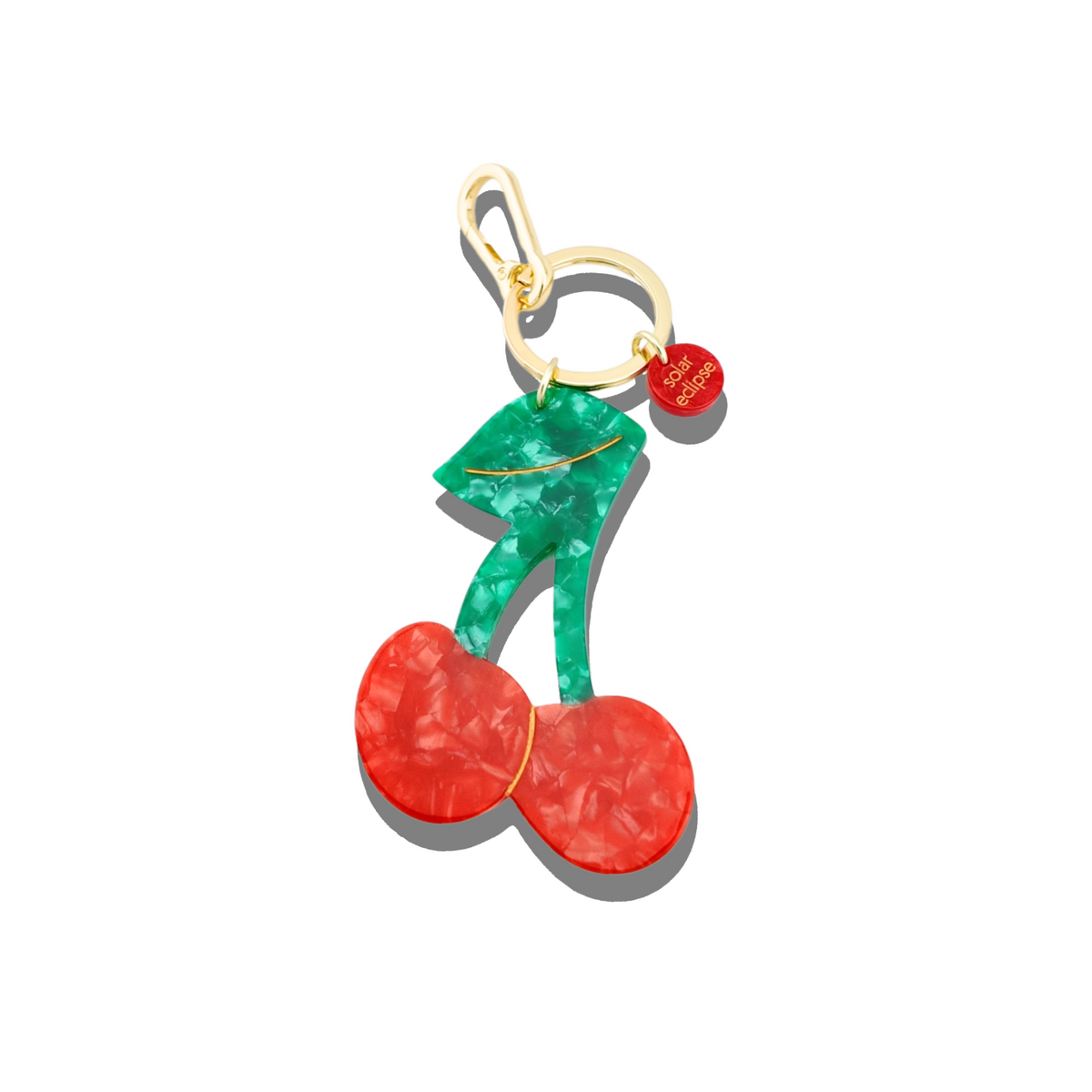 Cherry-shaped keychain with gold clasp on a white background