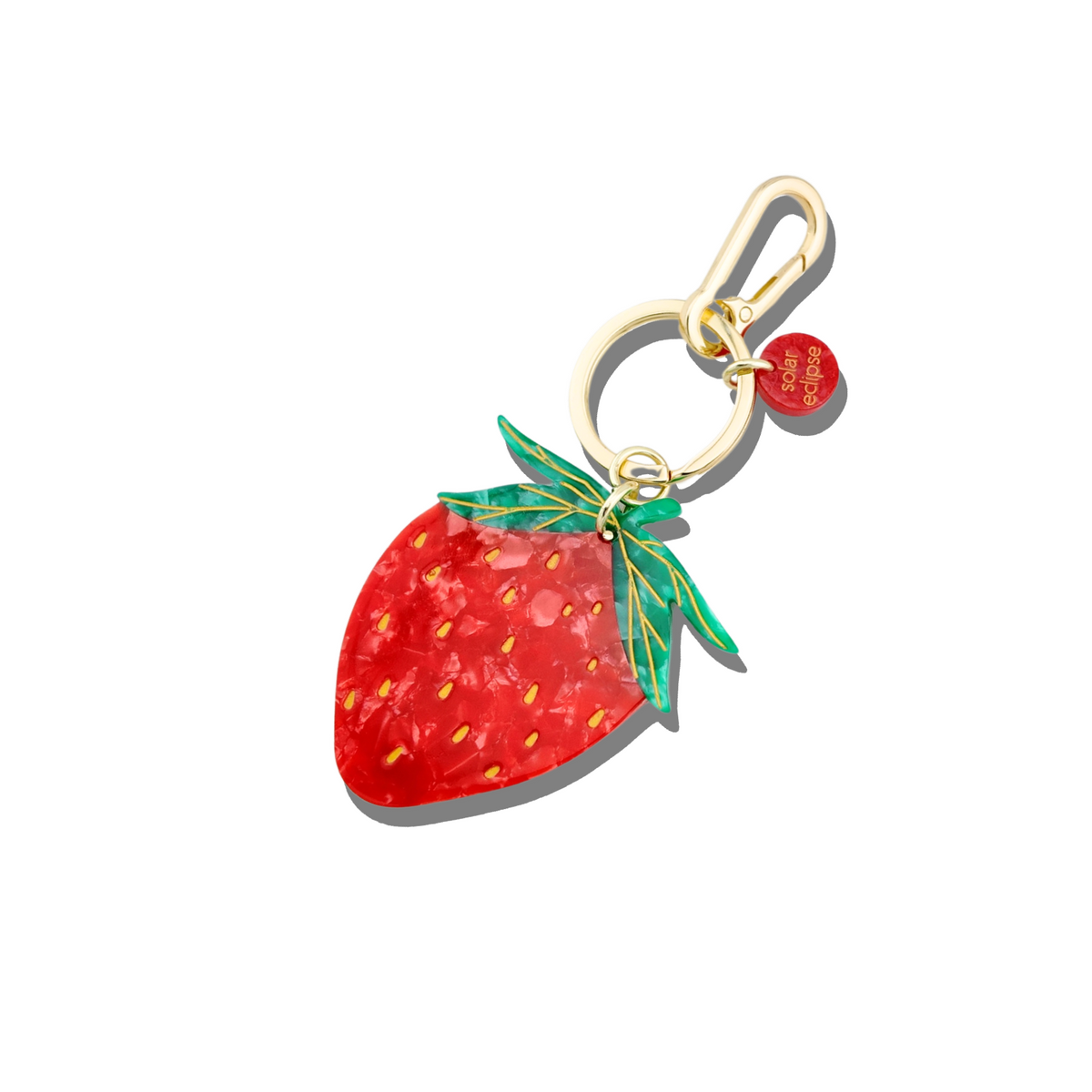 Strawberry-shaped keychain with a gold clasp on a white background