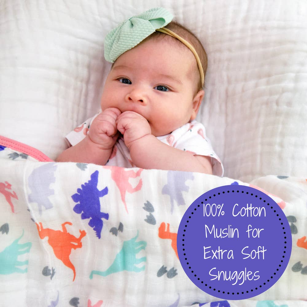 Baby wrapped in a colorful blanket with a text overlay about cotton muslin.