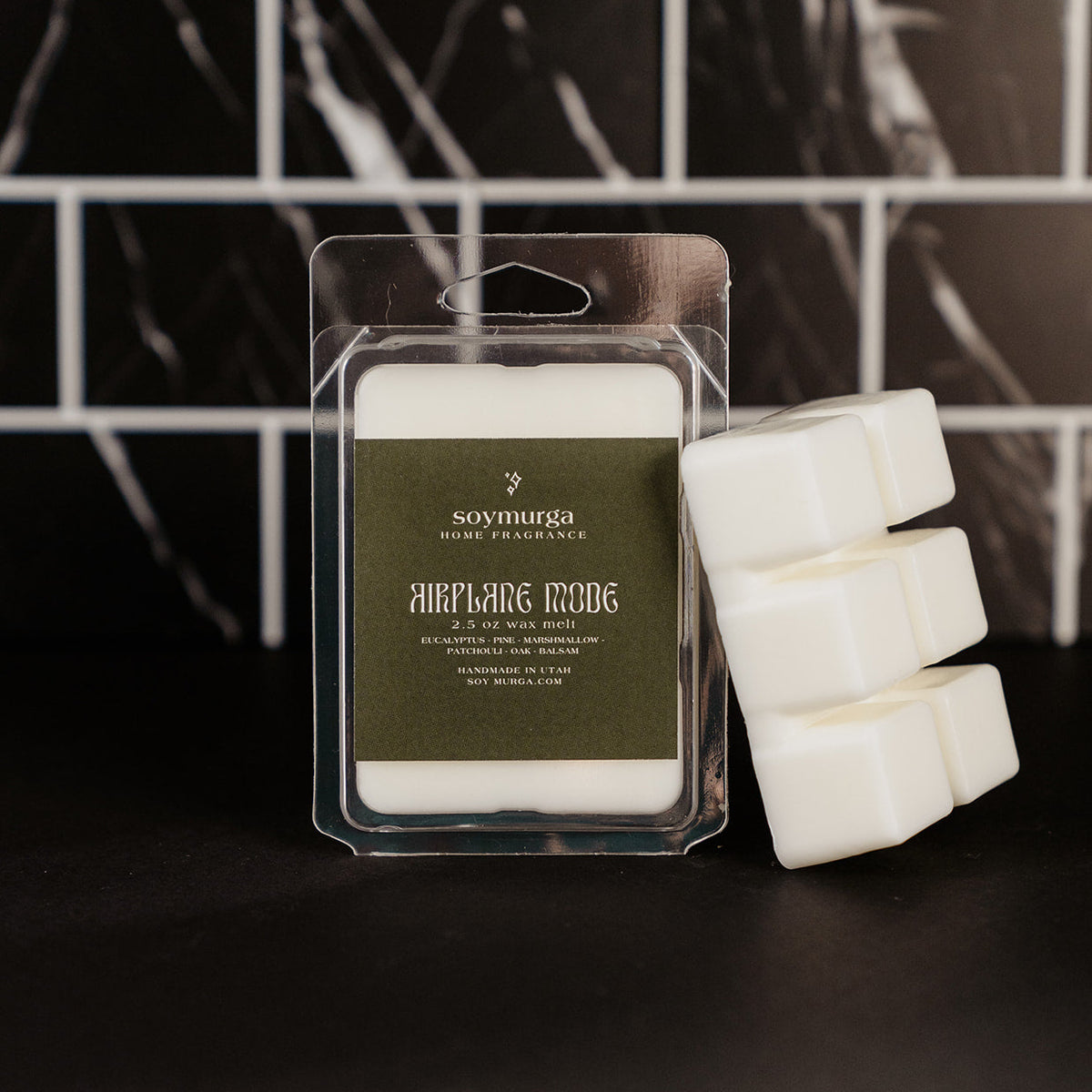 Airplane Mode wax melt in a plastic clamshell container. 