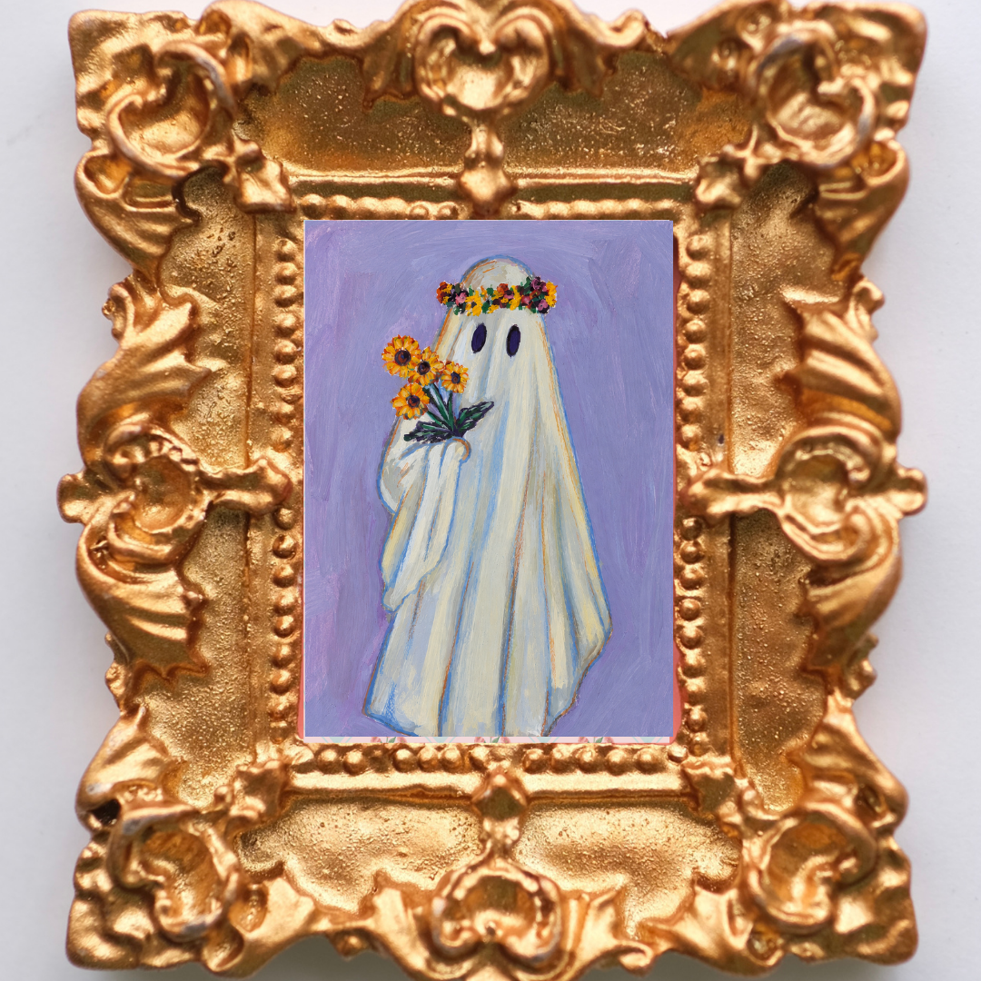 Sweet ghost hovers with a handful of flowers and flower crown inside an ornate gold frame magnet. 