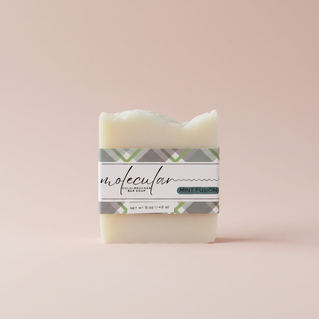 Rough white bar soap with a green plaid label. 