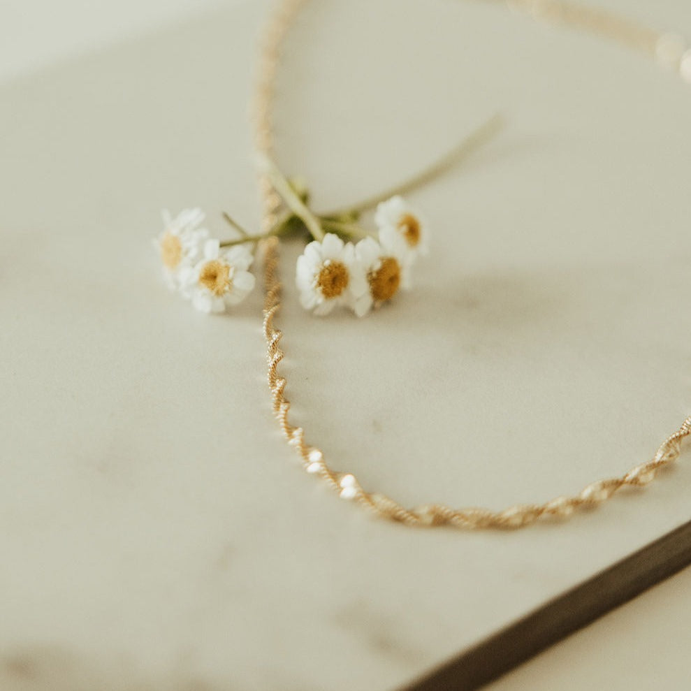 The Amelia Gold Filled Twist Necklace is the perfect piece to stack with other&nbsp;necklaces or wear as a stand alone accessory. She’s 18k gold filled, tarnish and wear resistant, and made to last. Hypoallergenic and nickel free, this unique and dainty 3mm chain is the perfect accessory all year long.&nbsp;16" length.
