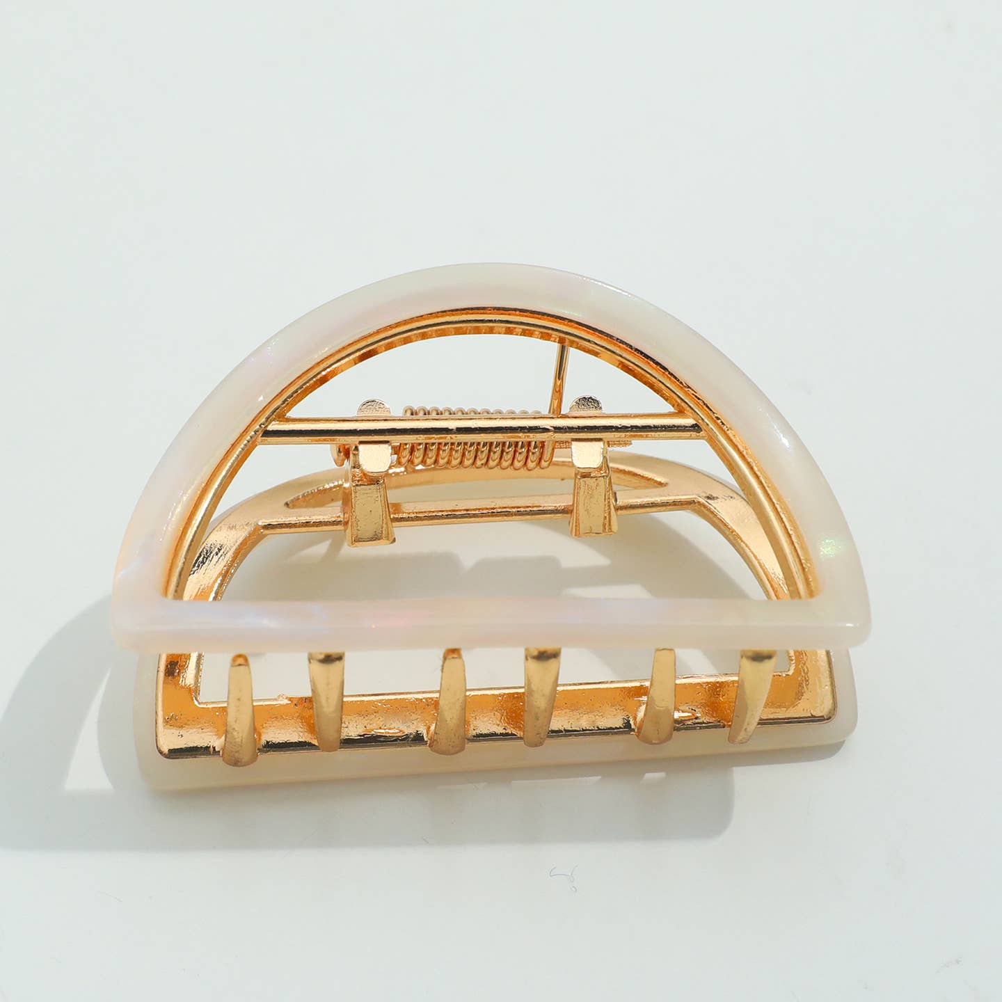 Elevate your hair game with this stunning half moon claw clip in soft opal. Featuring a durable metal claw mechanism, it delivers a secure grip that holds all day without slipping or snagging. The elegant crescent shape flatters any hair type and works beautifully for casual updos, half-up styles, or securing thick sections with ease. A versatile accessory that combines timeless design with dependable performance.

Details:

Small (2 inch)