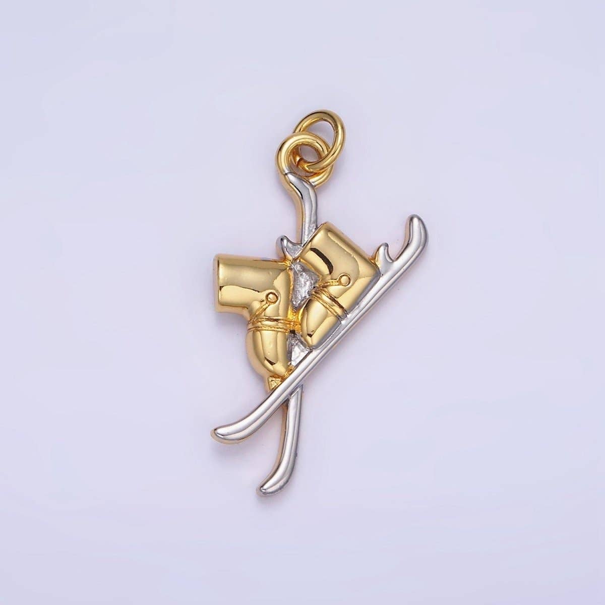 Hit the slopes in style with our Silver &amp; Gold Ski Charm. This dual-toned treasure captures the thrill of the mountain in a miniature, high-detail design featuring a pair of classic skis with mounted boots.