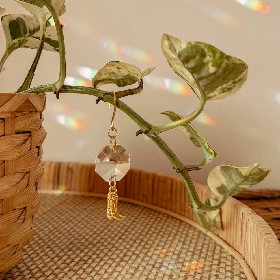 These delicate plant charms hang gracefully from vines, featuring a brass cowboy boot charm and suncatcher crystal. As direct sunlight hits the crystals, sparkles dance around to create a dreamy, light-filled atmosphere. Perfect for hanging on vines or trailing plants! Coordinates beautifully with natural, bohemian, minimal, hippie, retro, &amp; whimsical decor styles.
