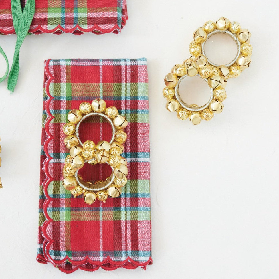 Bring festive charm and elegance to your holiday table with these handcrafted metal jingle bell napkin rings. Featuring a radiant gold finish and tied with natural jute, this set of four adds a cozy, welcoming accent to every dining experience.