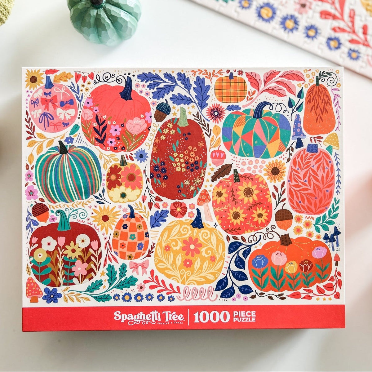 Above view of patchwork pumpkins puzzle. Graphics done in a patchwork style. Lots of cheerful pumpkins with cute and quirky designs. 