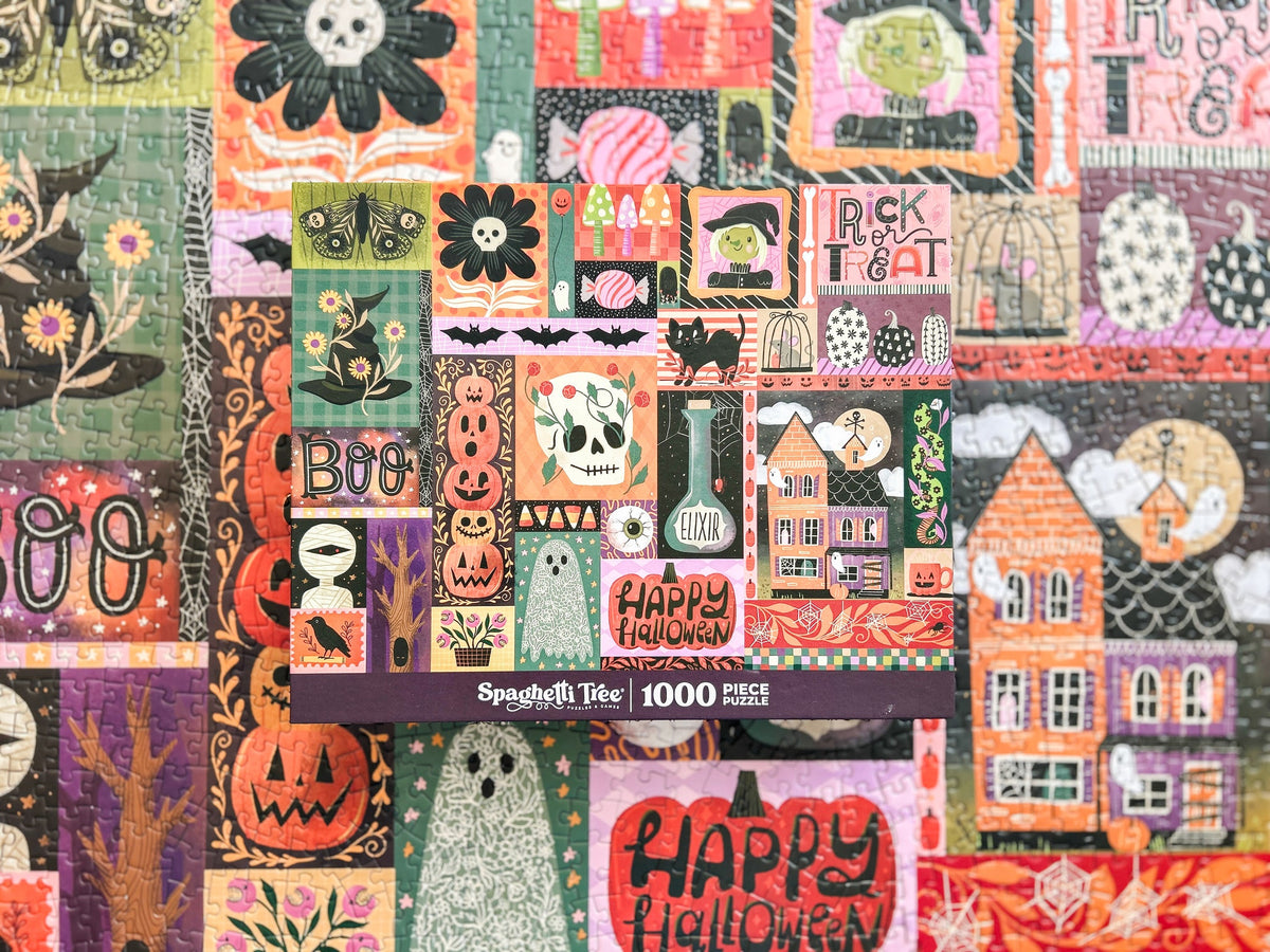 Above view of halloween puzzle. Patchwork style graphics of spooky halloween things like pumpkins, spiders, witches hat, ghost, ect. 
