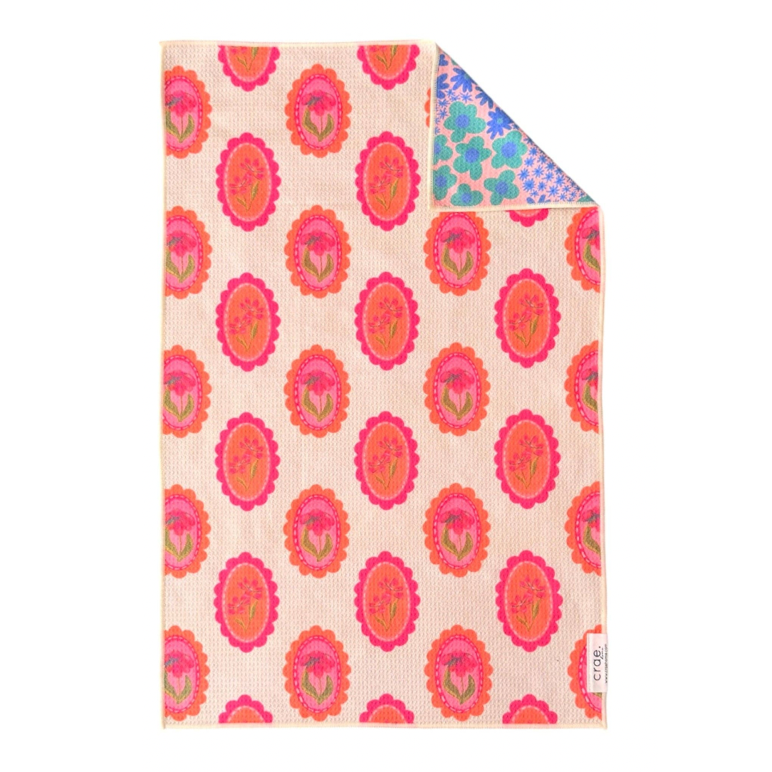 Floral patterned fabric with pink and orange flowers on a beige background